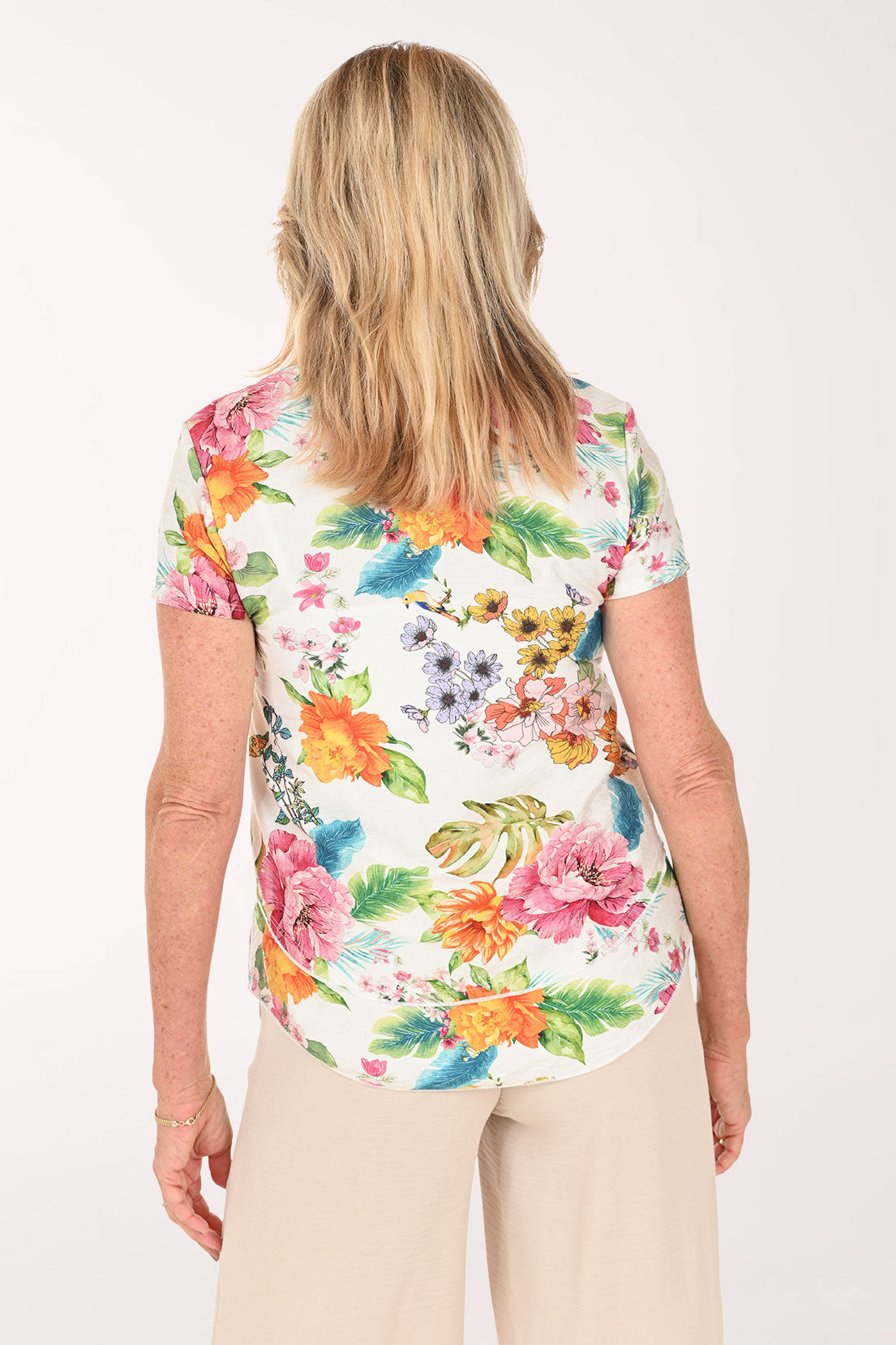 Woman wearing a short sleeve white multi floral top