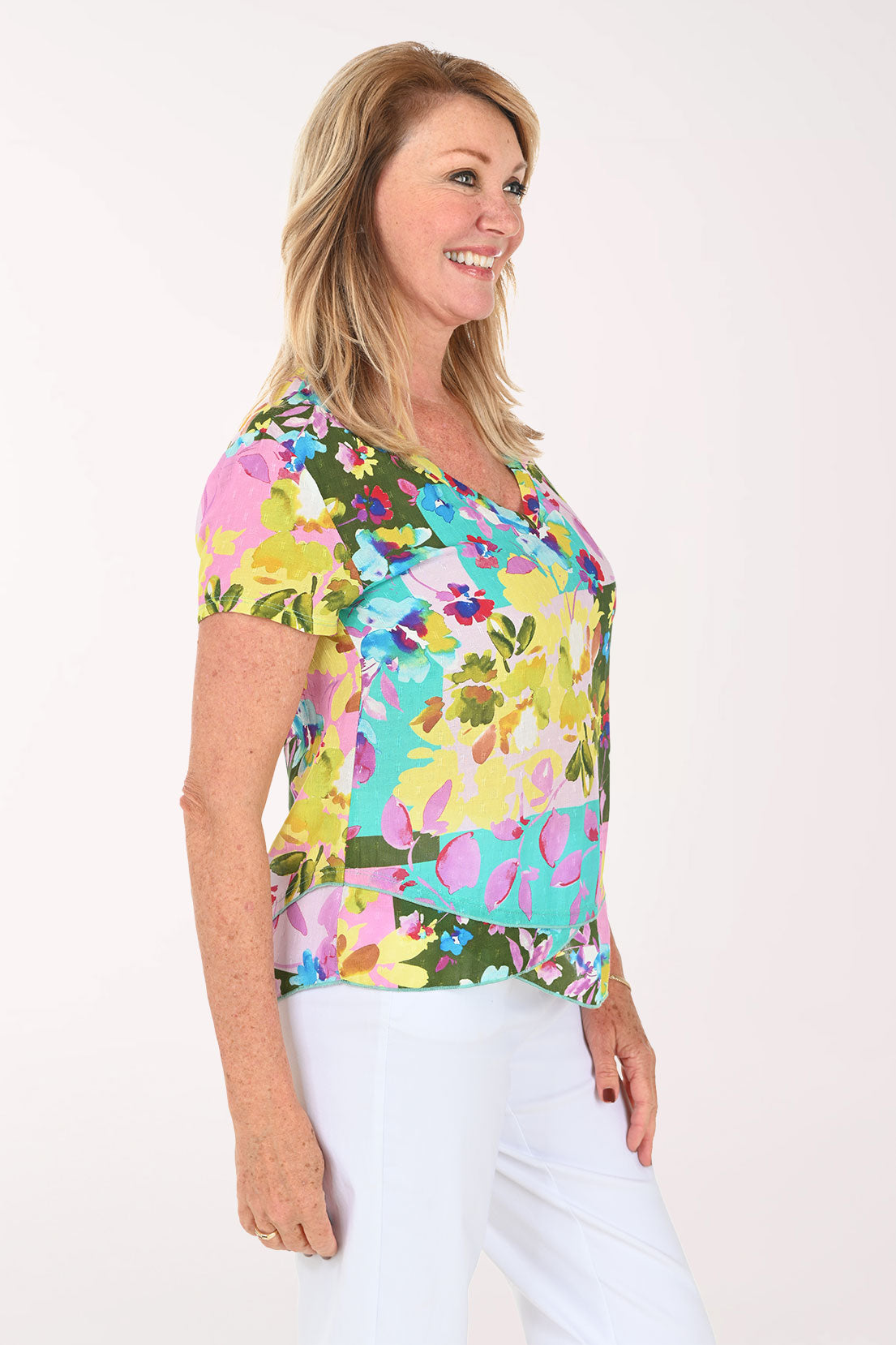 Woman wearing a multicolored orchid print short sleeve top