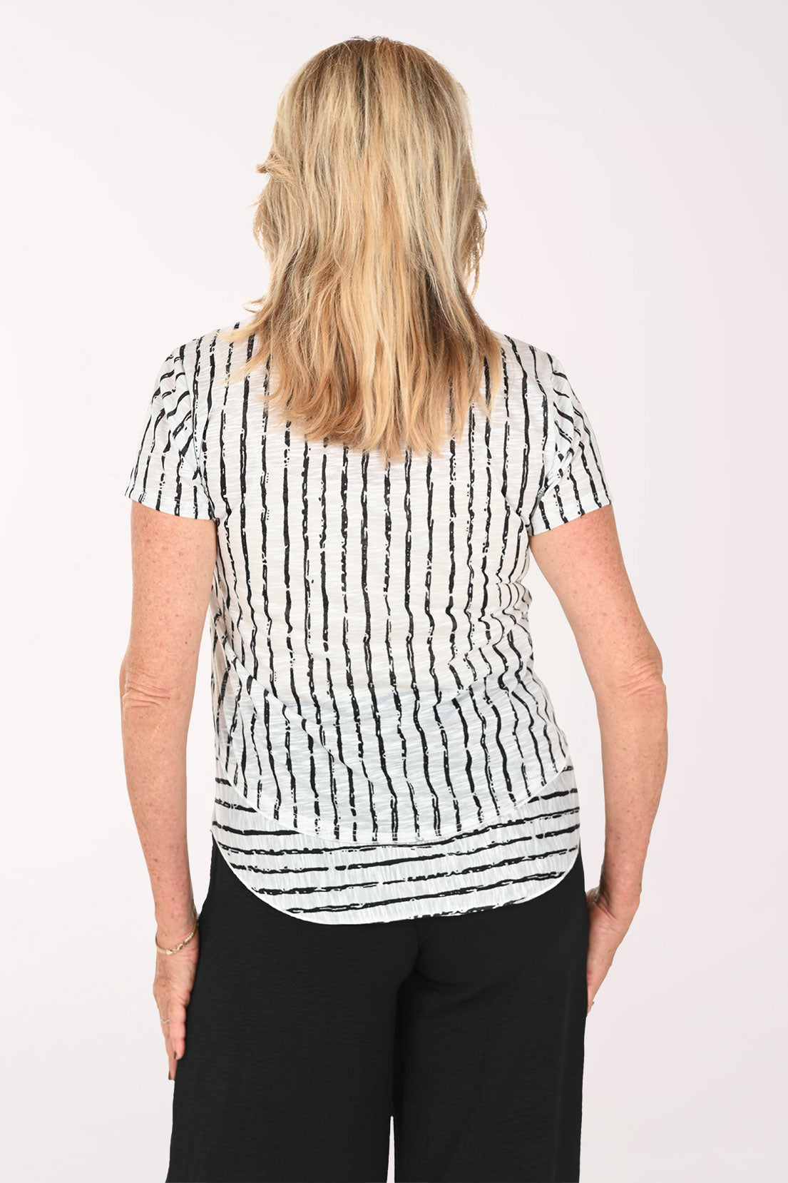 Woman wearing a black and white striped short sleeve tee