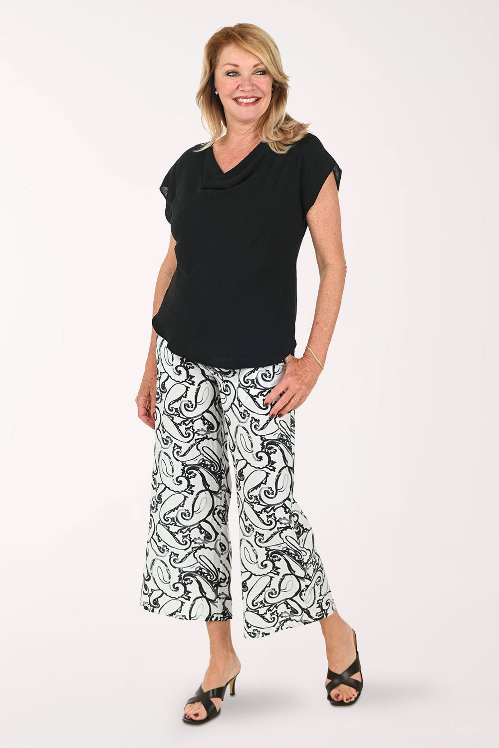 Woman wearing black and white paisley cropped bottoms