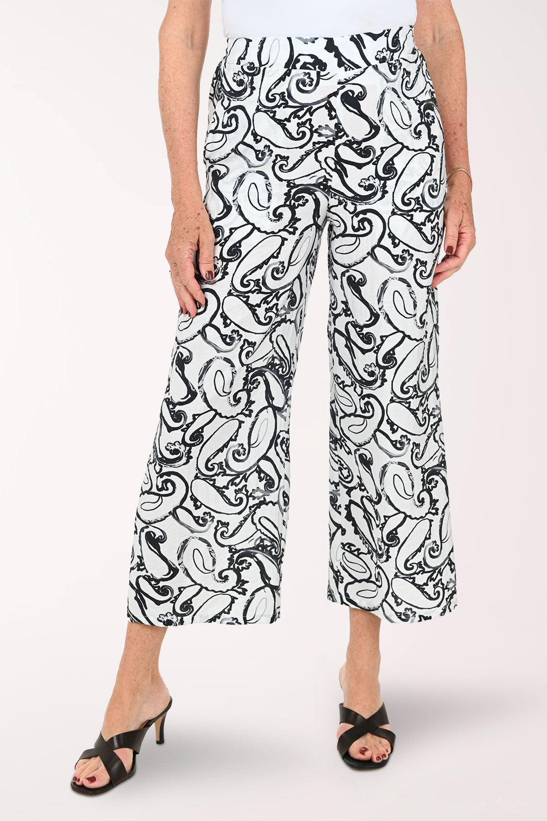 Woman wearing black and white paisley cropped bottoms