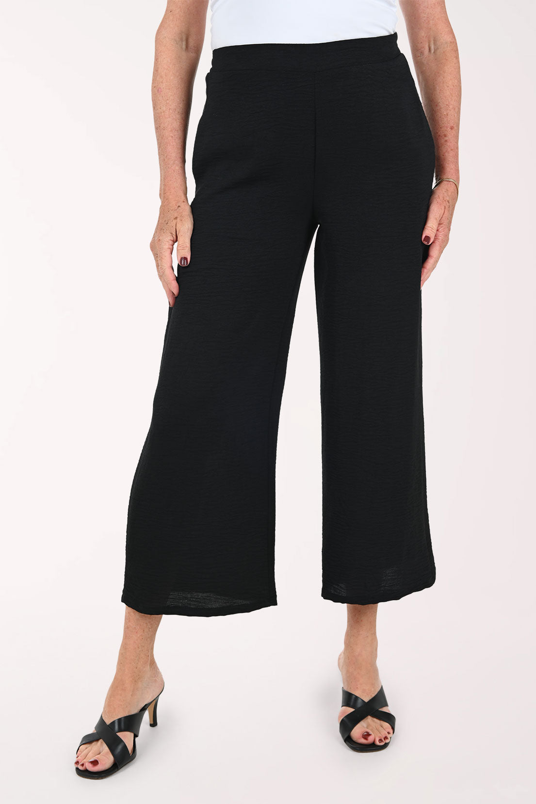 Woman wearing black flared crop pants