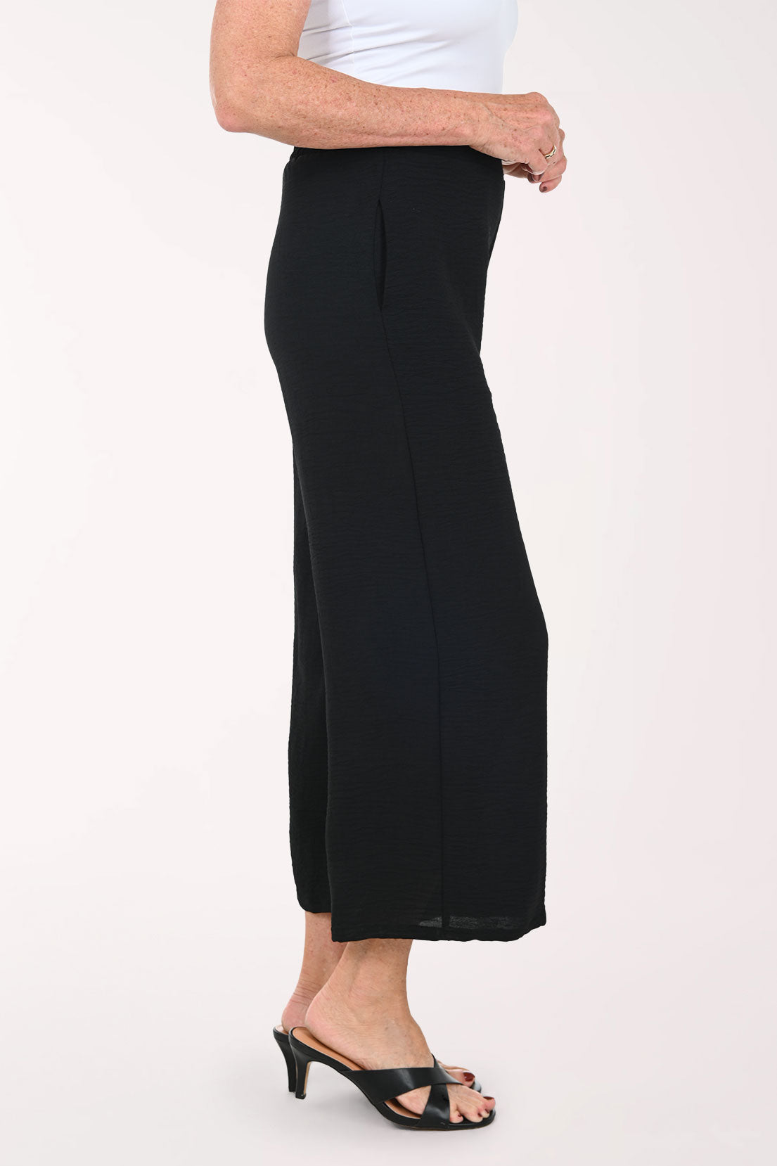 Woman wearing black flared crop pants