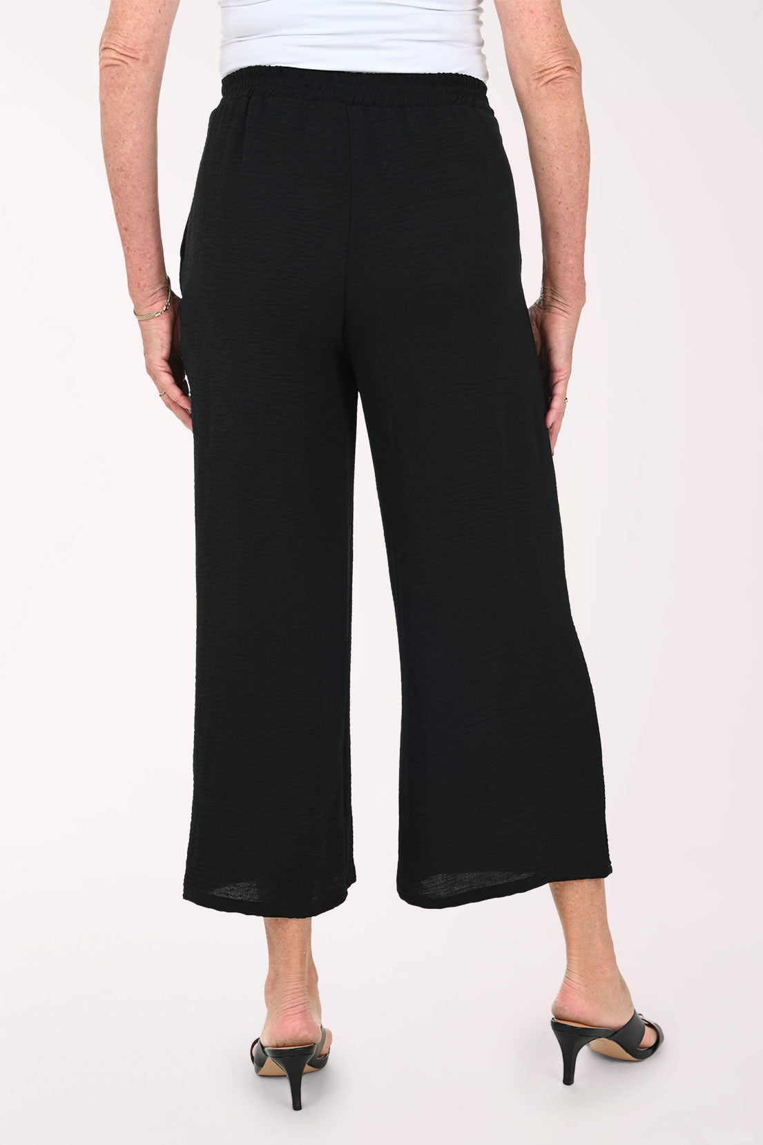 Woman wearing black flared crop pants