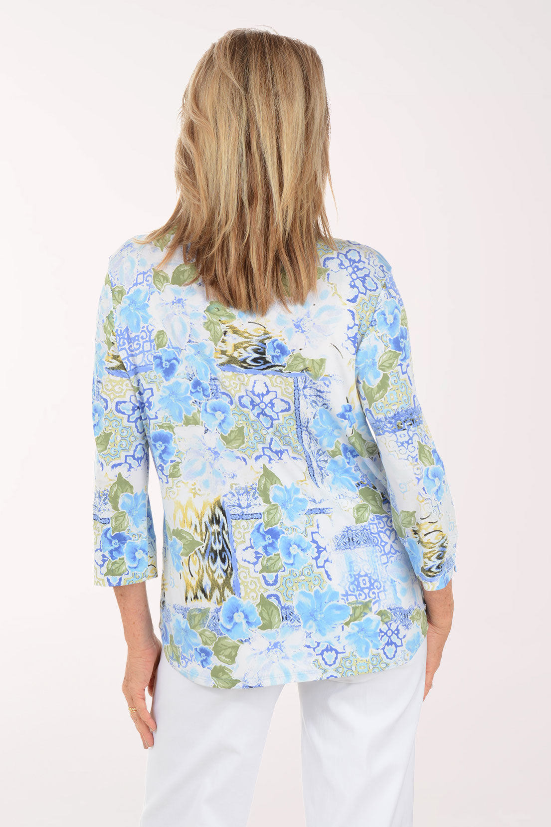 Woman wearing a floral blouse with a white background