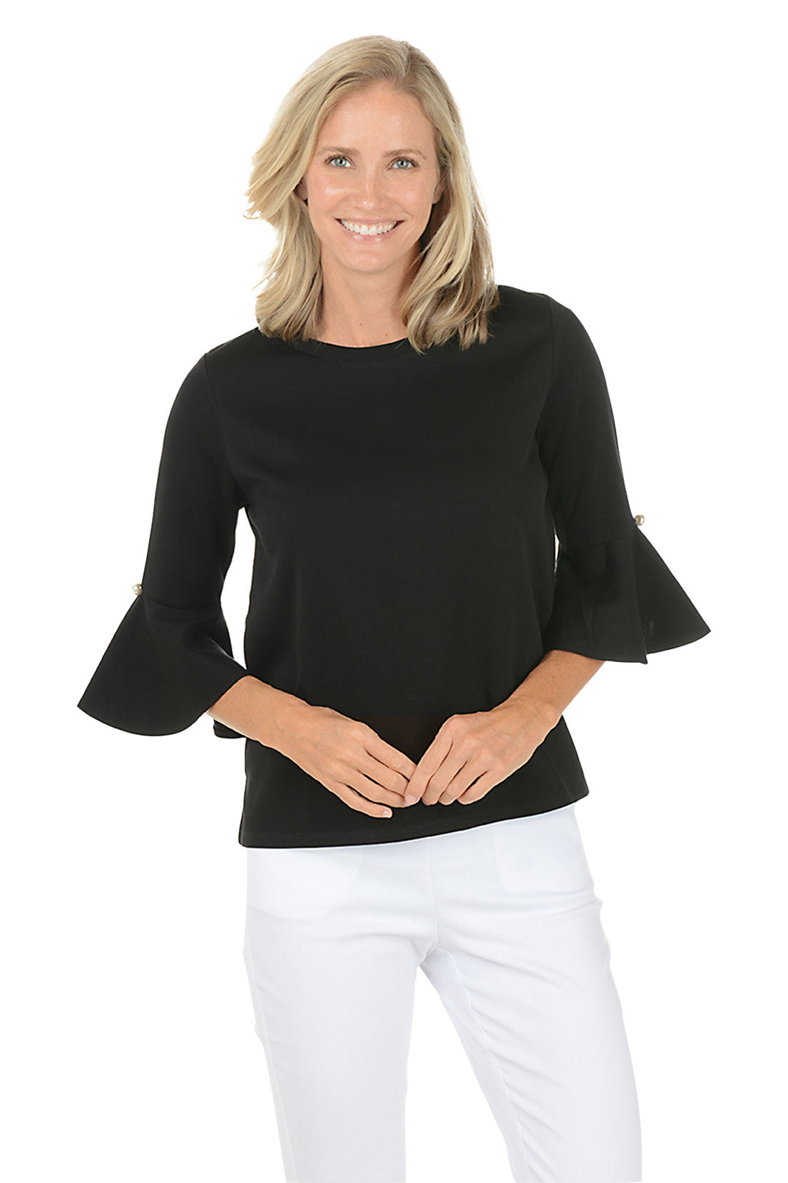 Woman wearing a black bell-sleeve top and white pants on a white background. Second front shot.