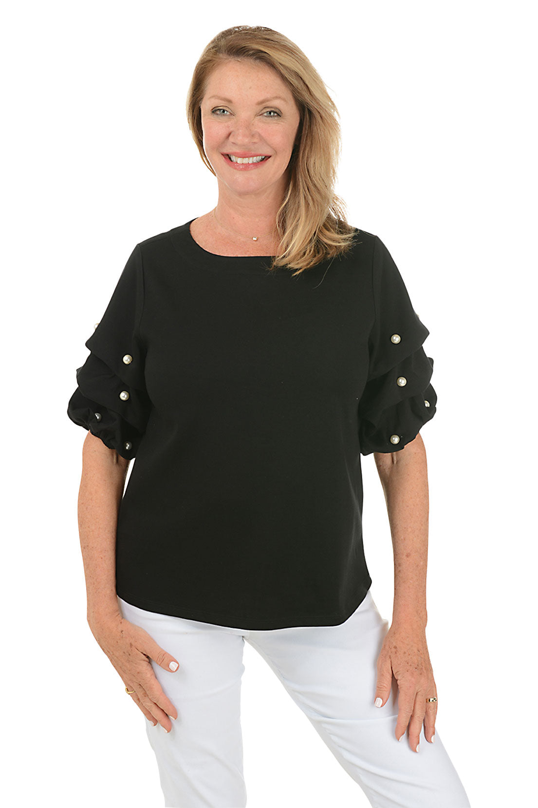 A front shot of a model wearing a black top with a scoop neck and pearl gathered elbow sleeves with embellishments. She is also wearing white pants.