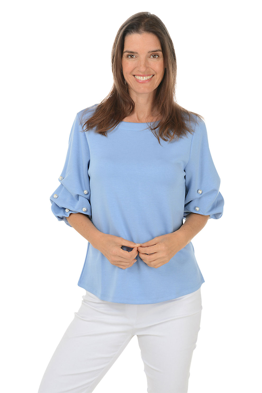 A front shot of a model wearing a corn flower top with a scoop neck and pearl gathered elbow sleeves with embellishments. She is also wearing white pants.