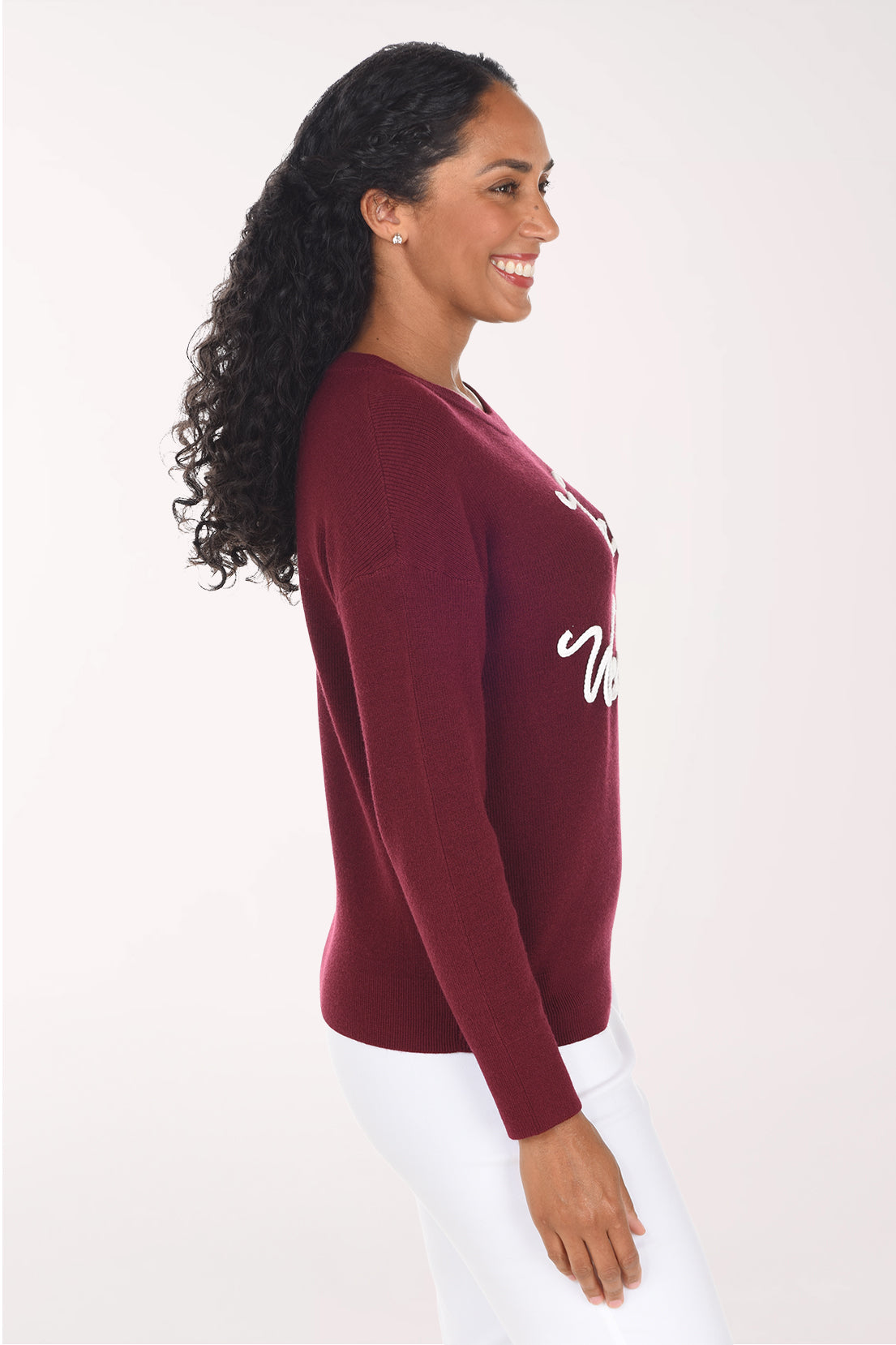 Side view of the wine red sweater showing the drop shoulder and long cuffed sleeve.