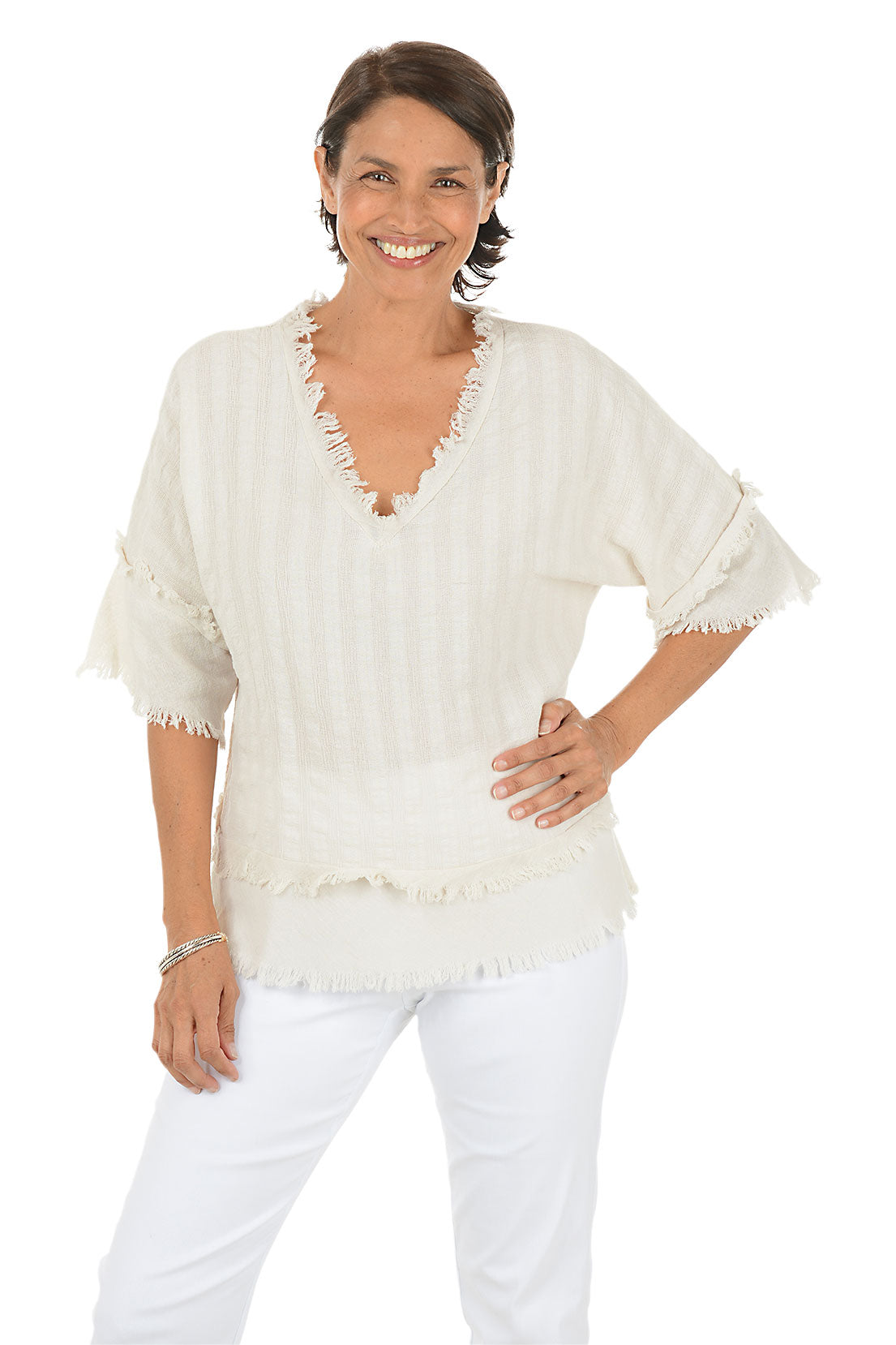 Woman wearing a beige blouse with ruffled details on a white background