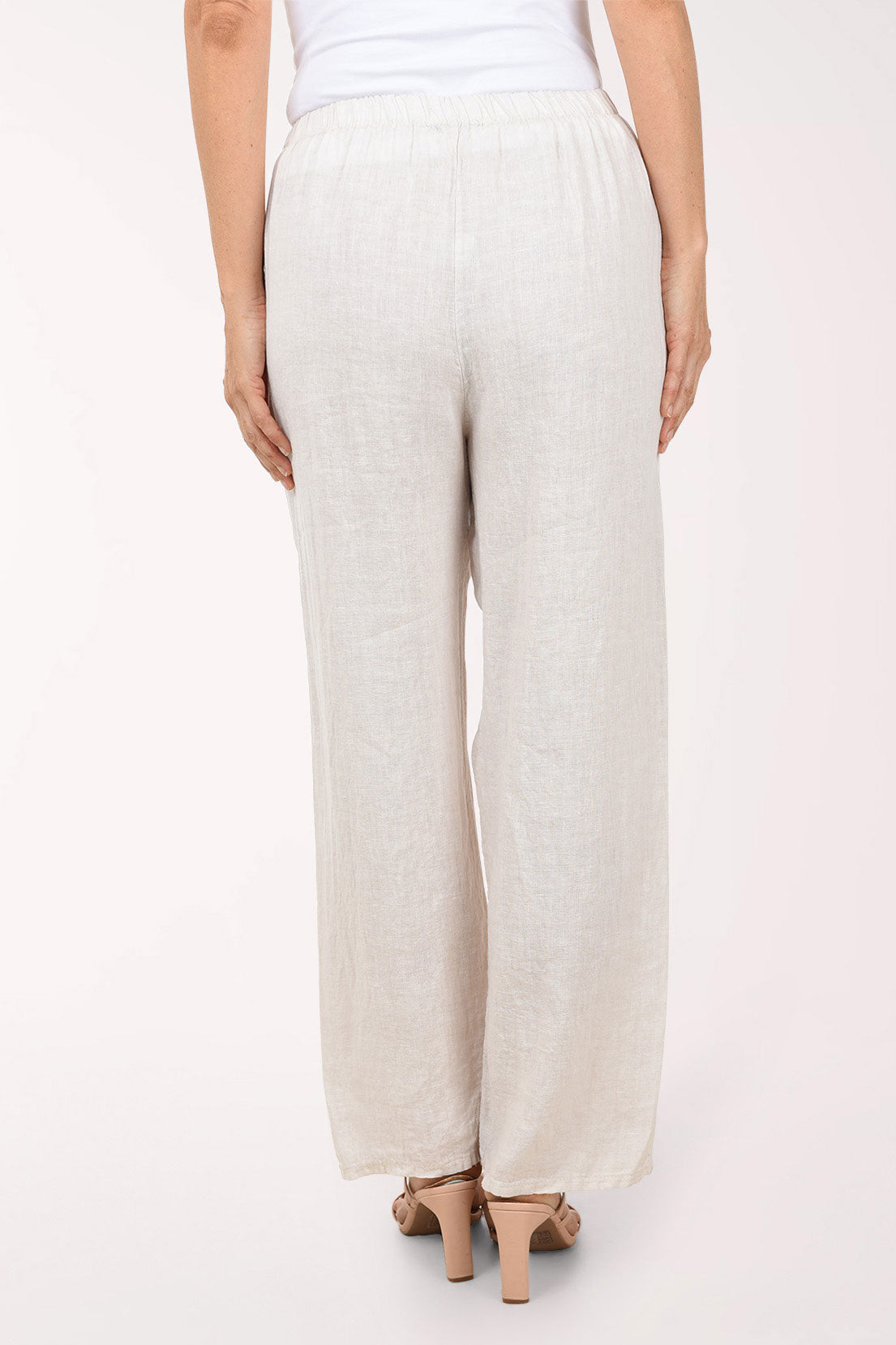Beige wide-leg pants worn by a person on a white background