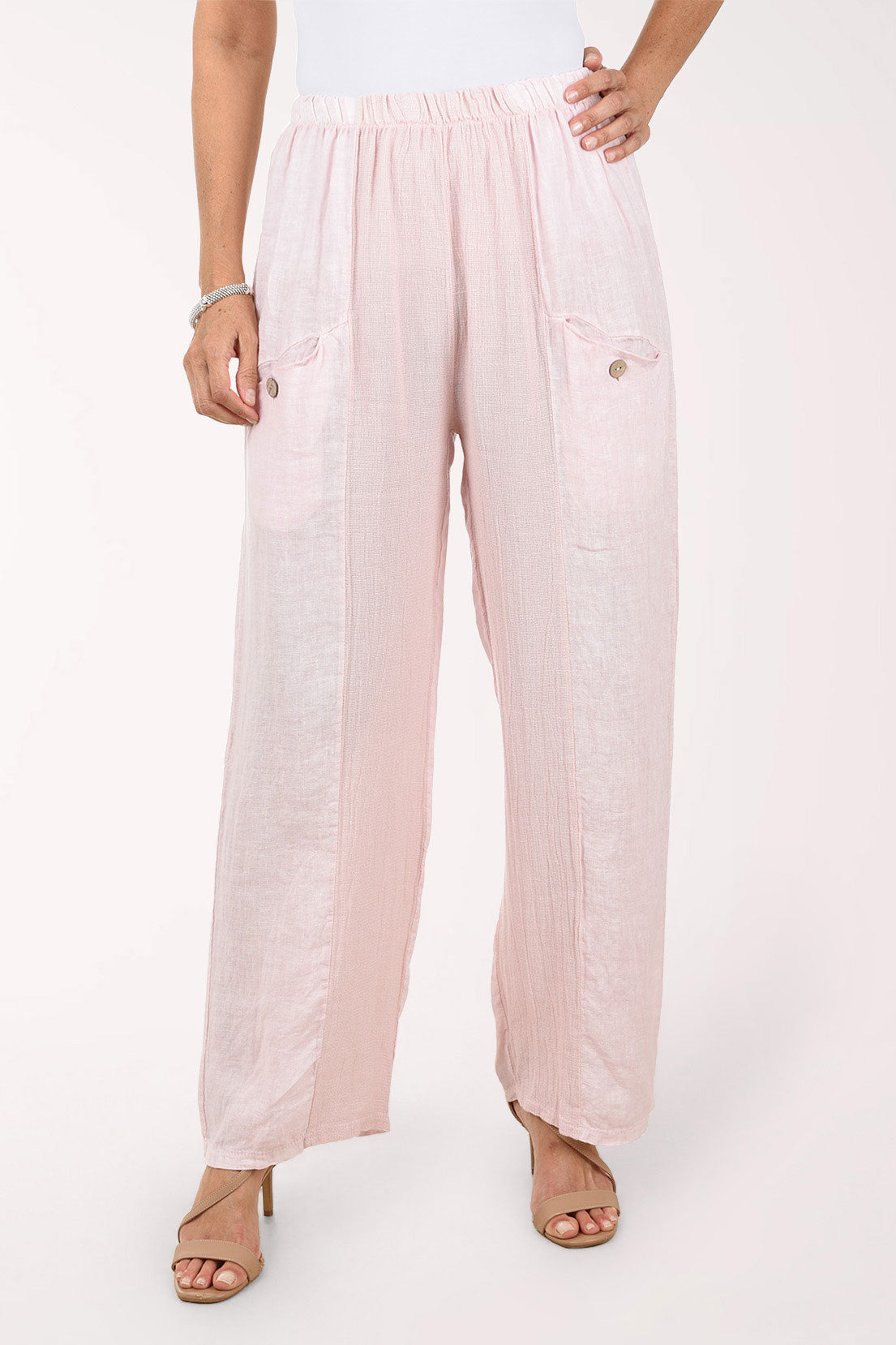 Light pink wide-leg pants worn by a person on a white background