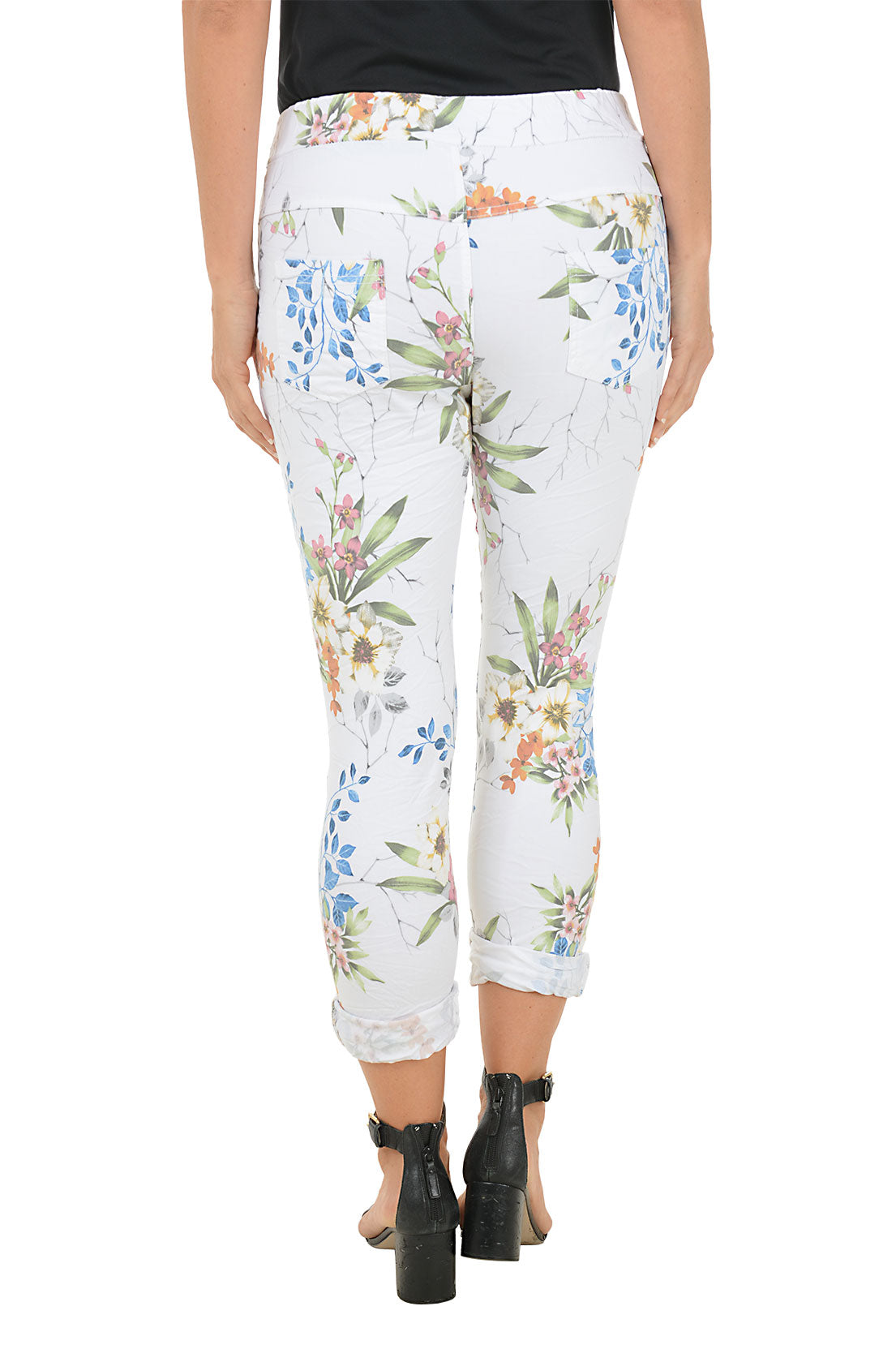 Floral-patterned pants worn by a person on a white background. Back shot.
