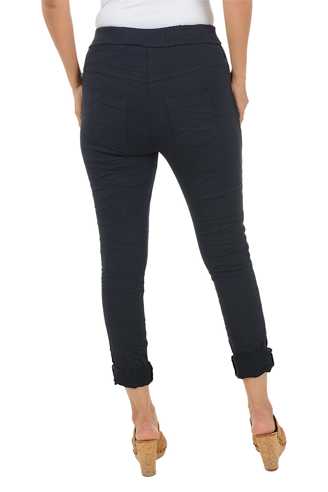 Navy blue pants worn by a person on a white background. Back shot.