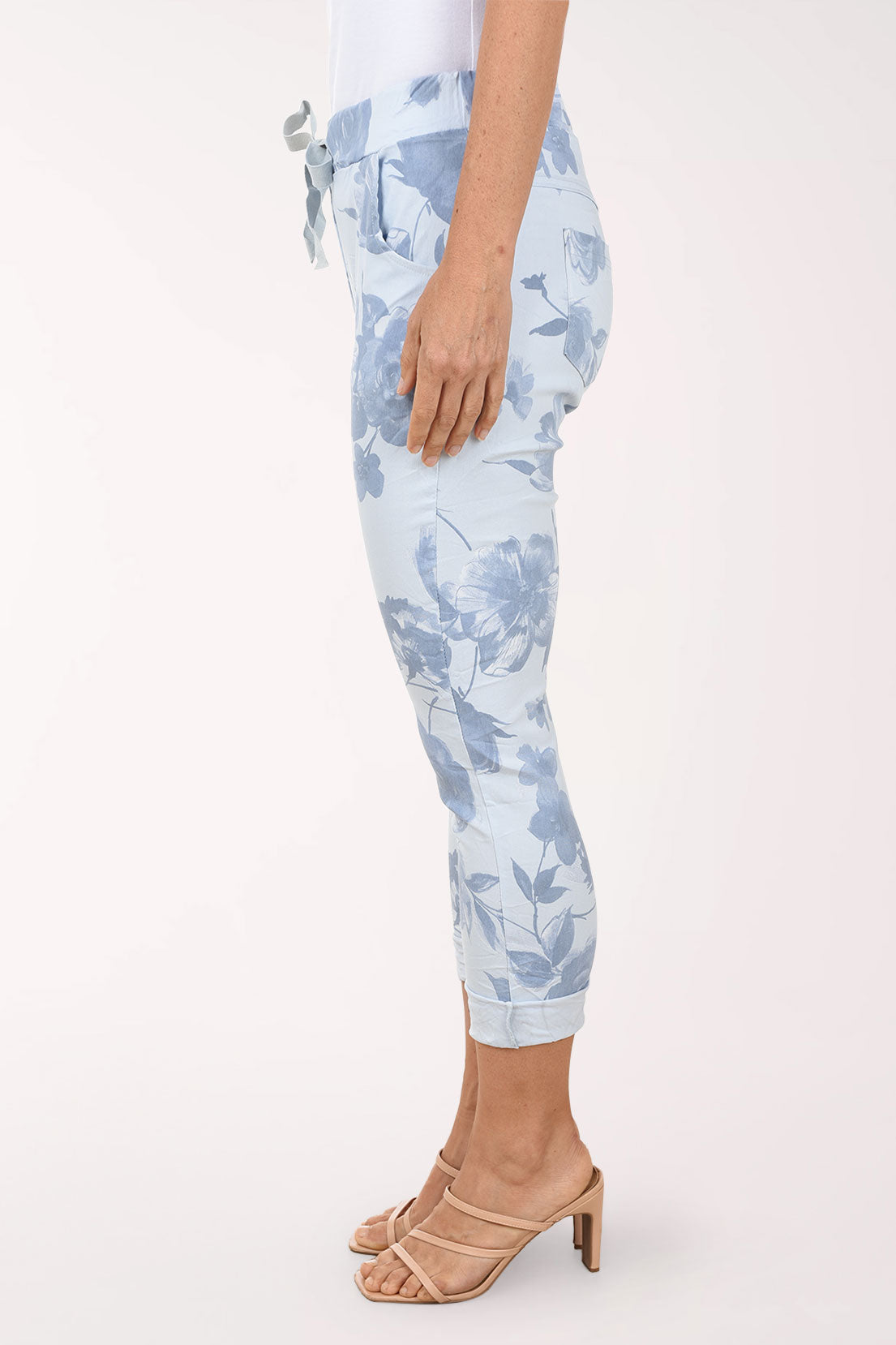 Light blue floral-patterned pants worn by a person on a white background