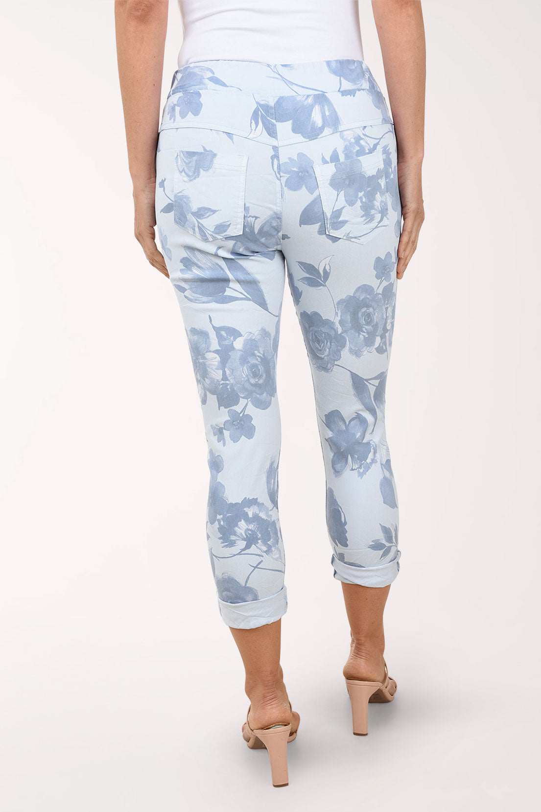 Light blue floral-patterned pants worn by a person on a white background