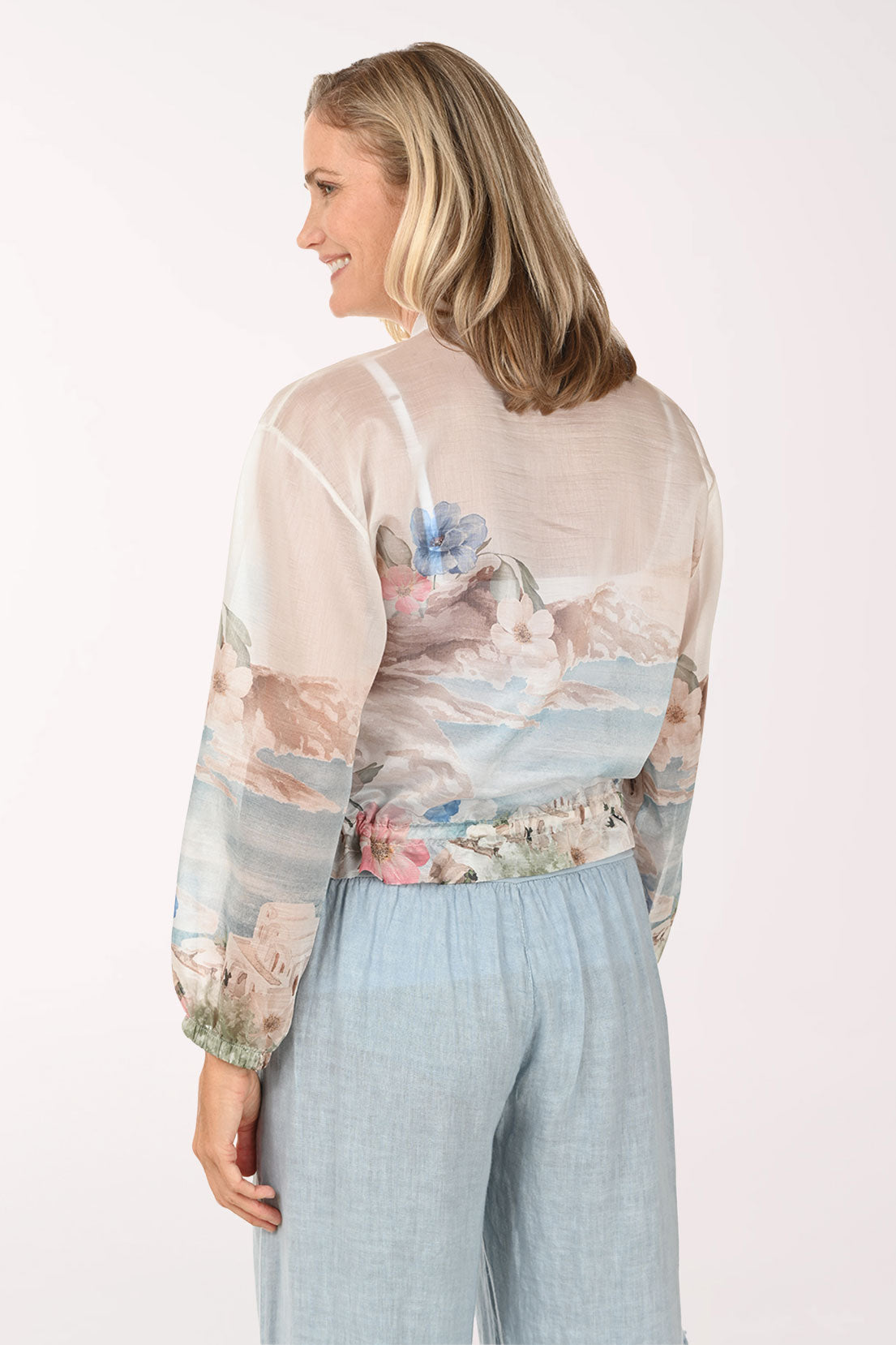 Woman wearing a beige floral jacket