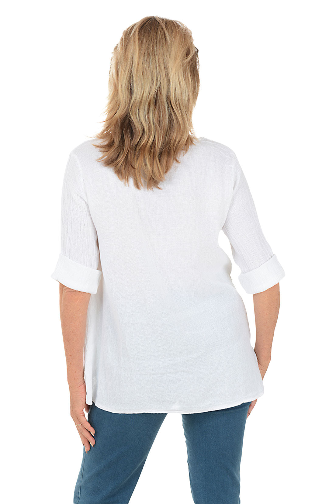 Woman wearing a white blouse and blue jeans on a white background. Back shot.