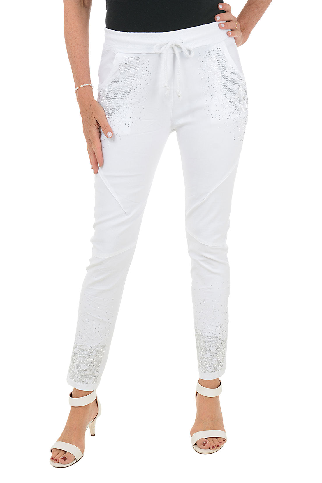 A front shot of a model wearing a white Jegging with leopard rhinestone embellishment, featuring a slim leg design, dual front and back pockets, and an adjustable drawstring waistband.