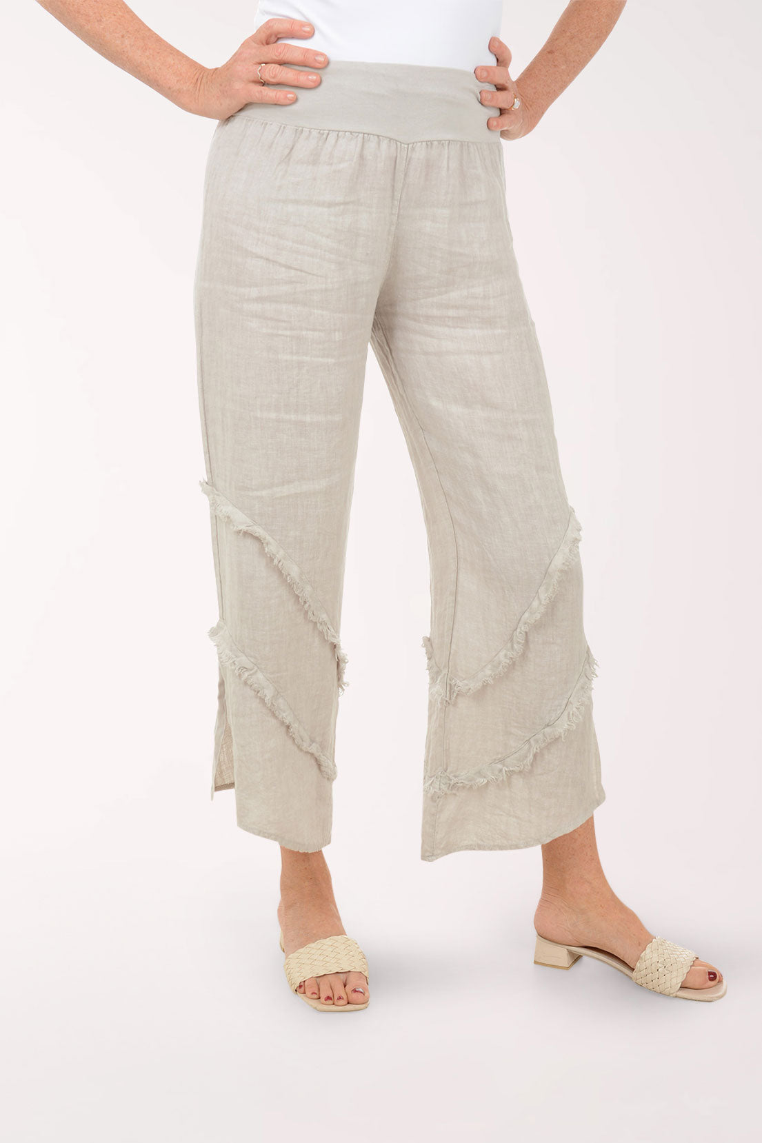 Woman wearing beige flowy pants.