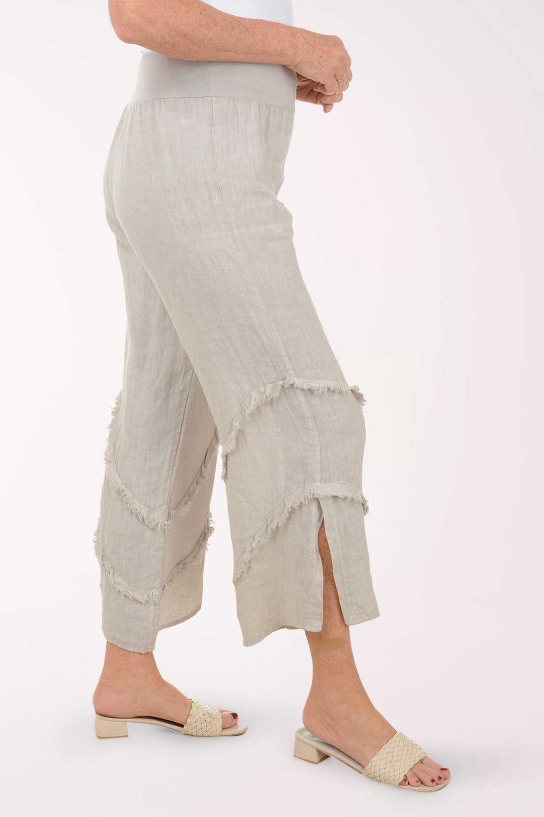 Woman wearing beige flowy pants.