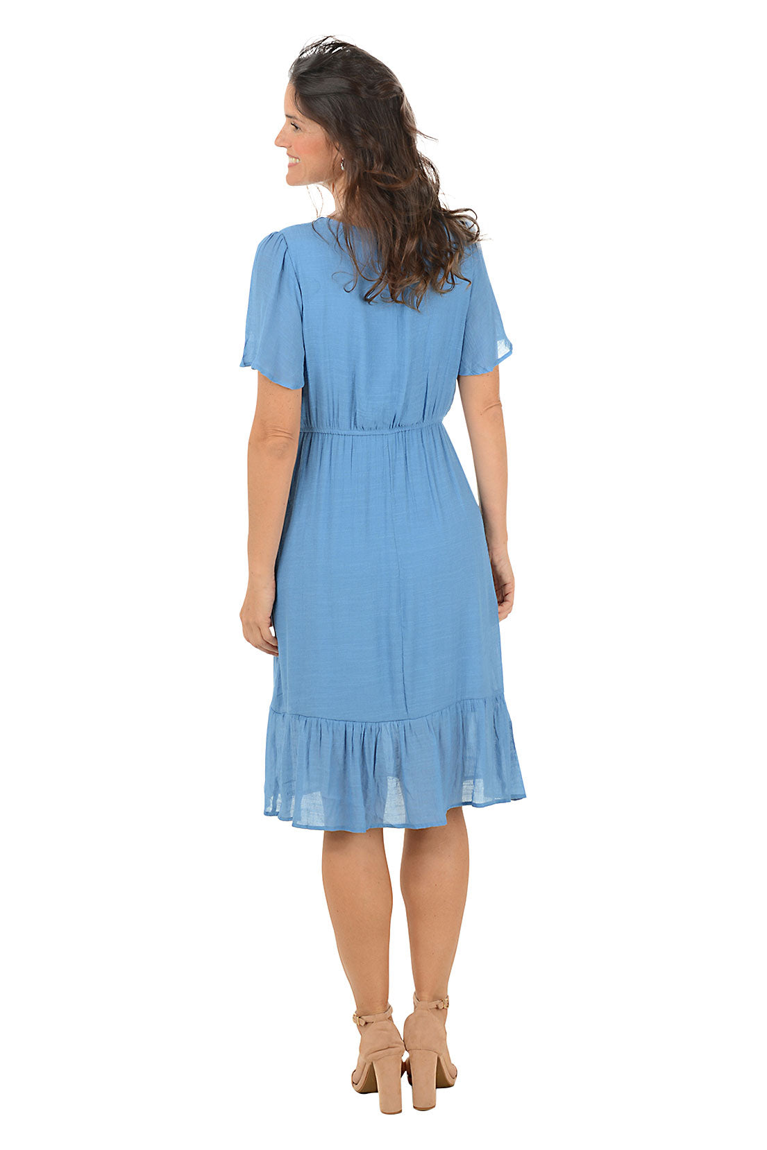 Woman wearing a blue dress on a white background. Back shot.