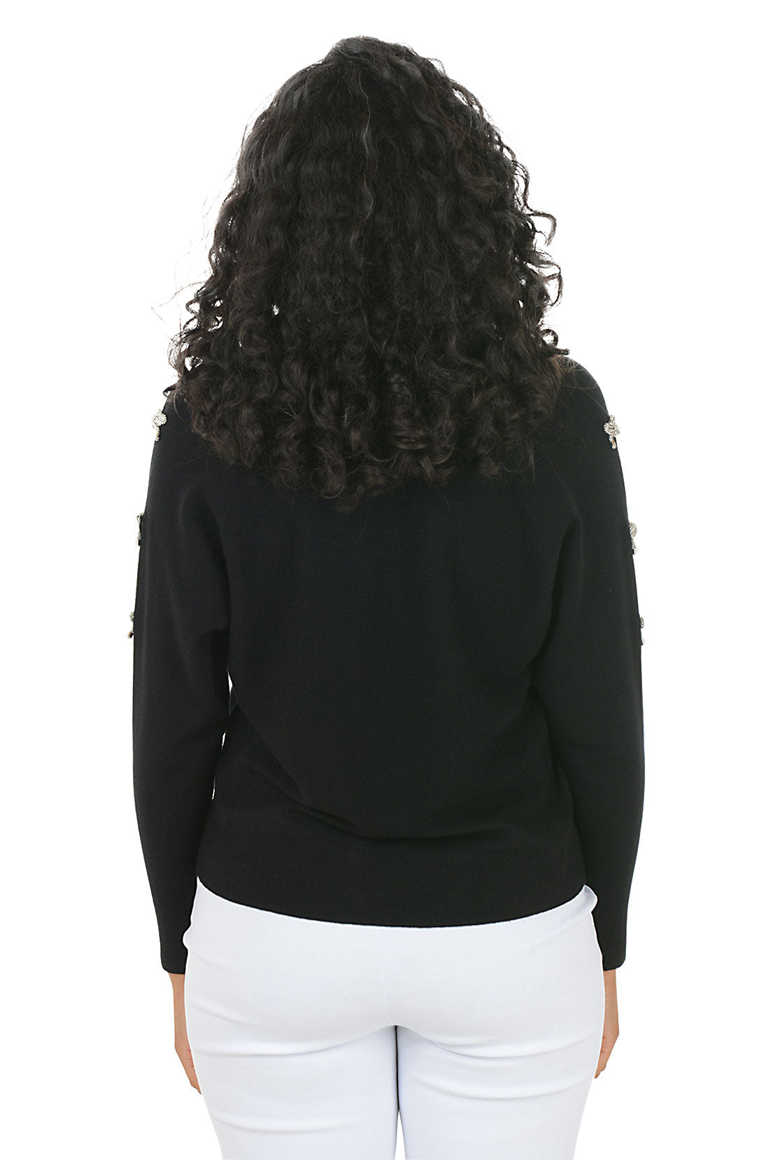 Woman wearing a black sweater with white bow embellishments on the sleeves on a white background. Back shot.
