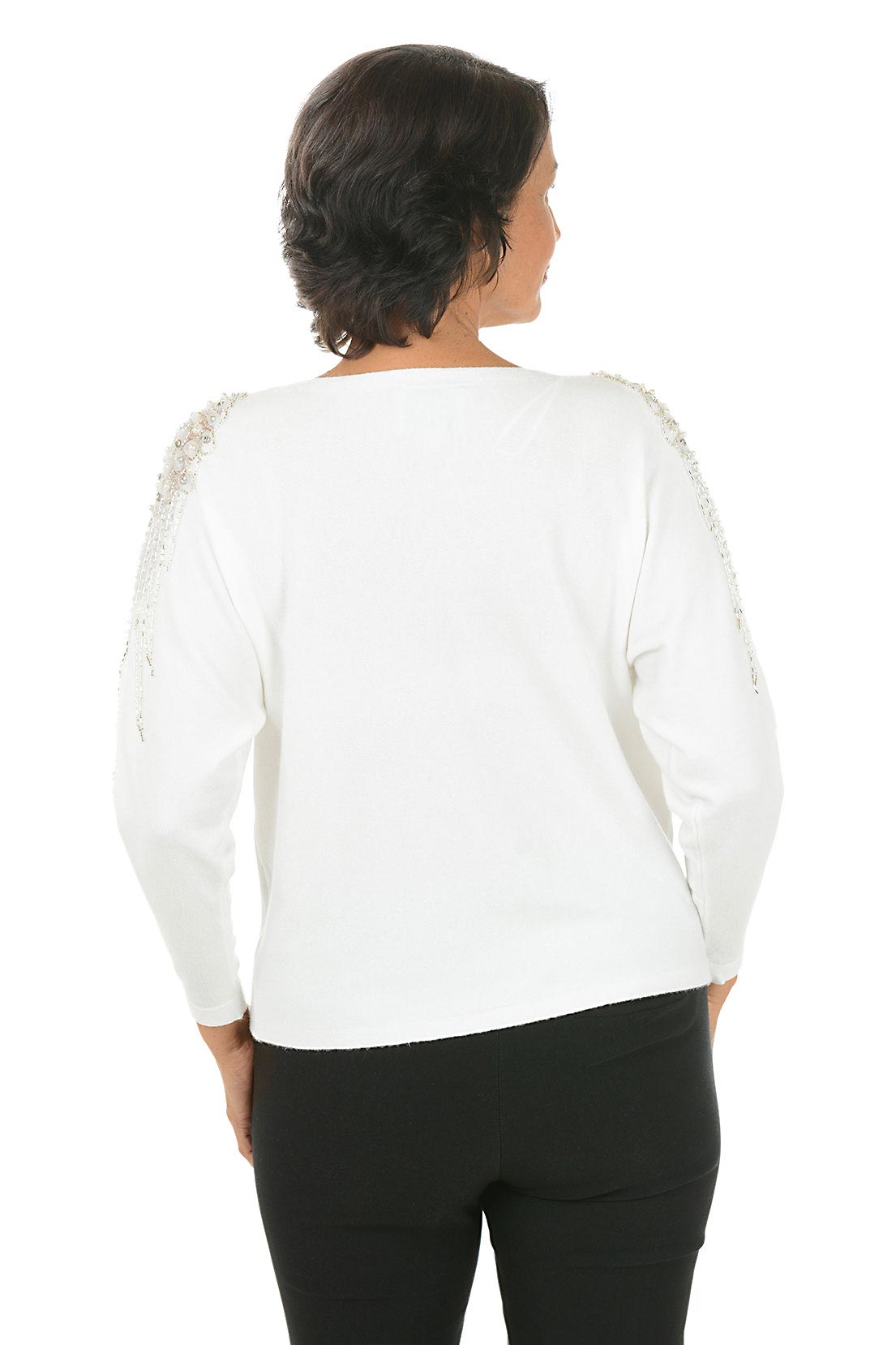 Woman wearing a white long sleeve sweater with sheer mesh angel wing embellishments with beaded and rhinestone accents on shoulders. Back shot.