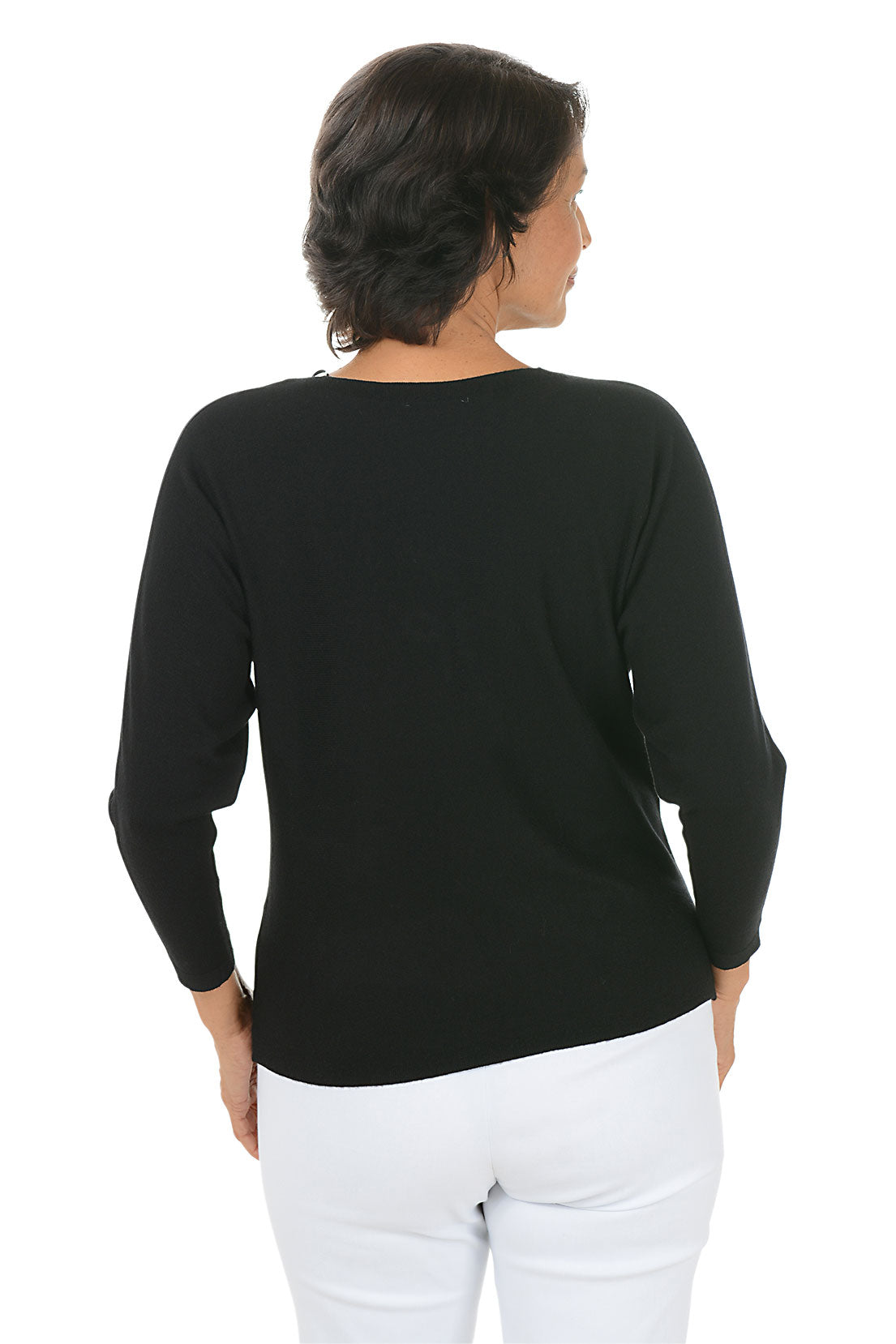 Woman wearing a black long sleeve sweater with rhinestone bow embellishments. Back shot.