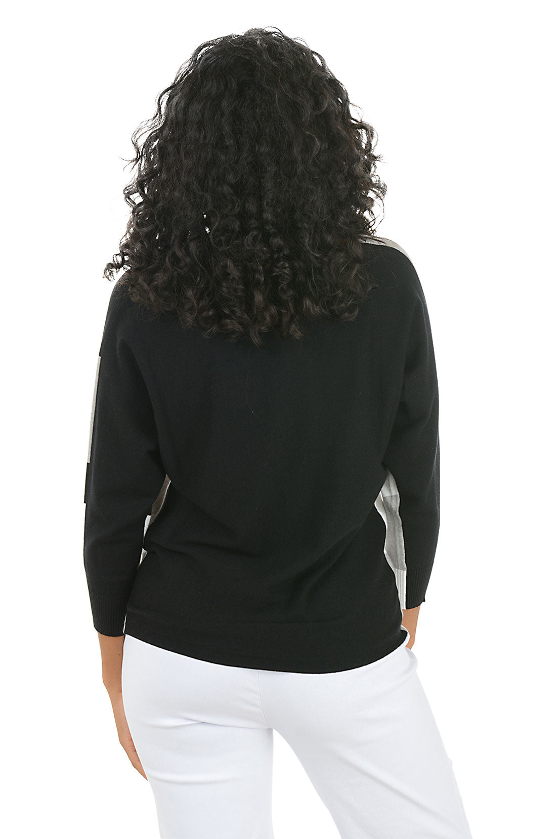 Woman wearing a black, gray, and white color-blocked sweater on a white background. Back shot.