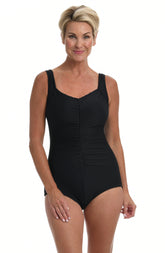 A woman wearing a black one-piece swimsuit with a girl leg.