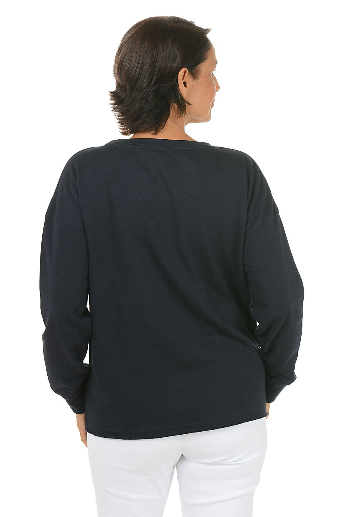 Person wearing a black sweater and white pants on a white background