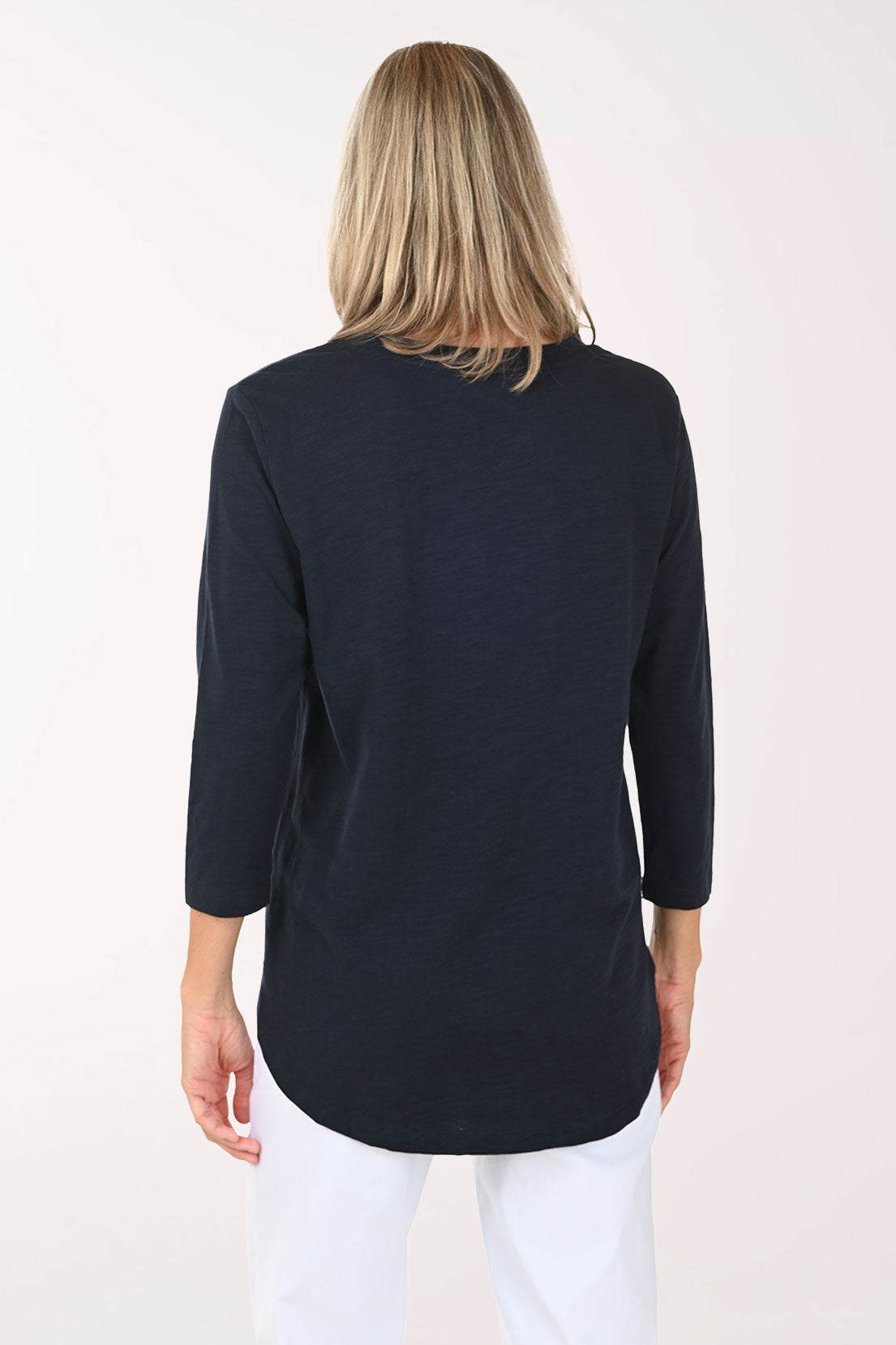 Woman wearing a white and navy 3/4 sleeve top with an anchor