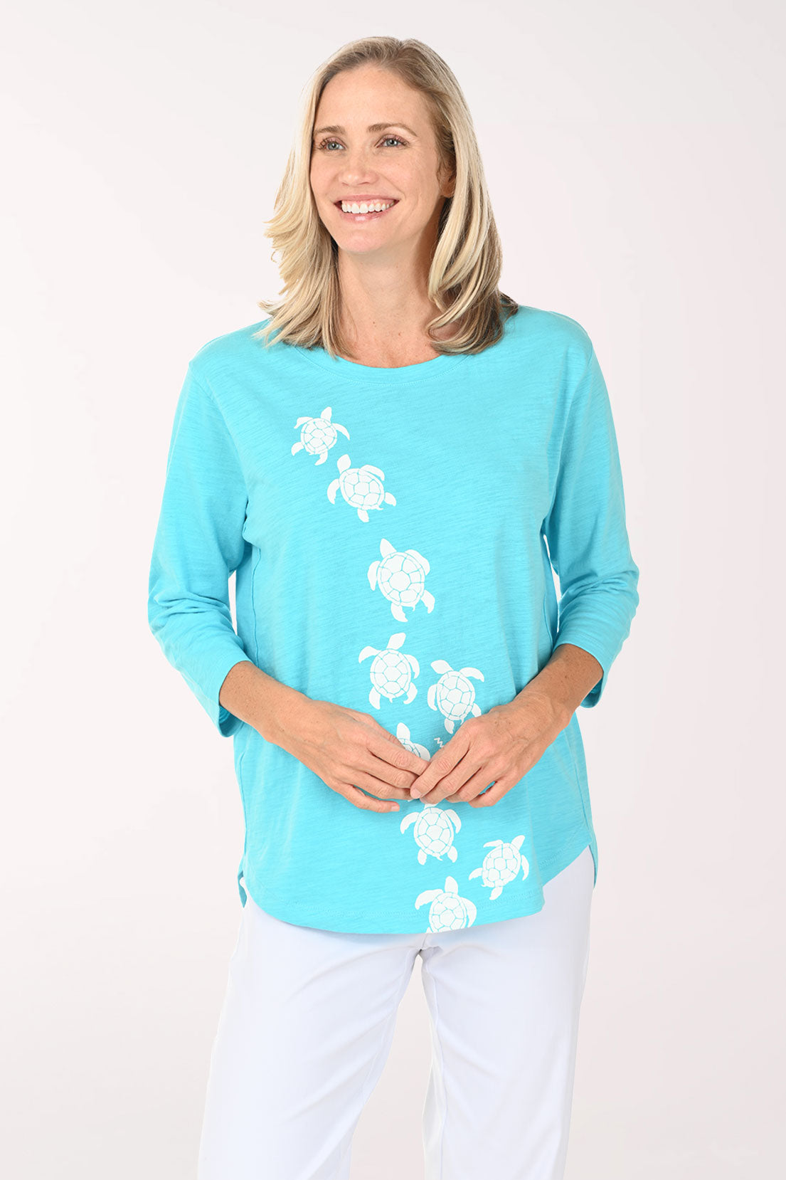 Woman wearing an aqua top with sea turtles