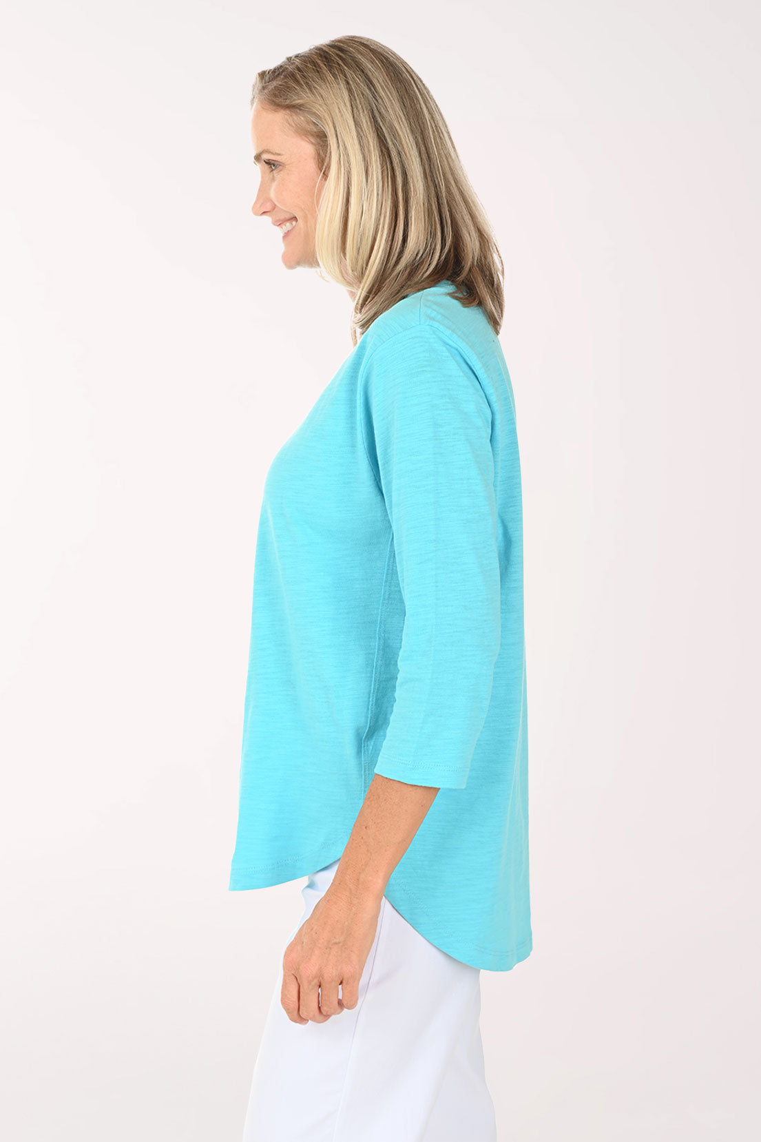 Woman wearing an aqua top with sea turtles