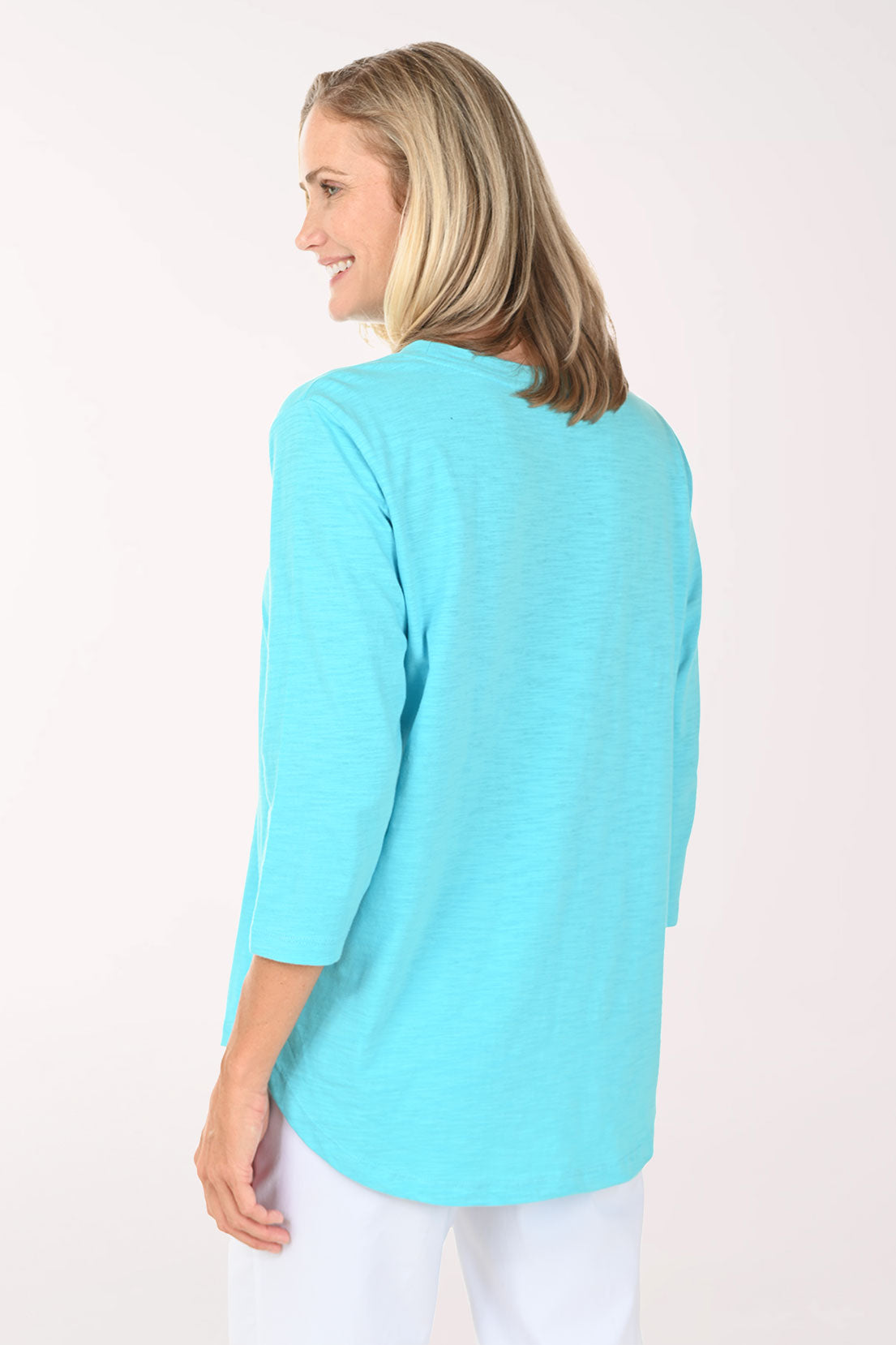 Woman wearing an aqua top with sea turtles