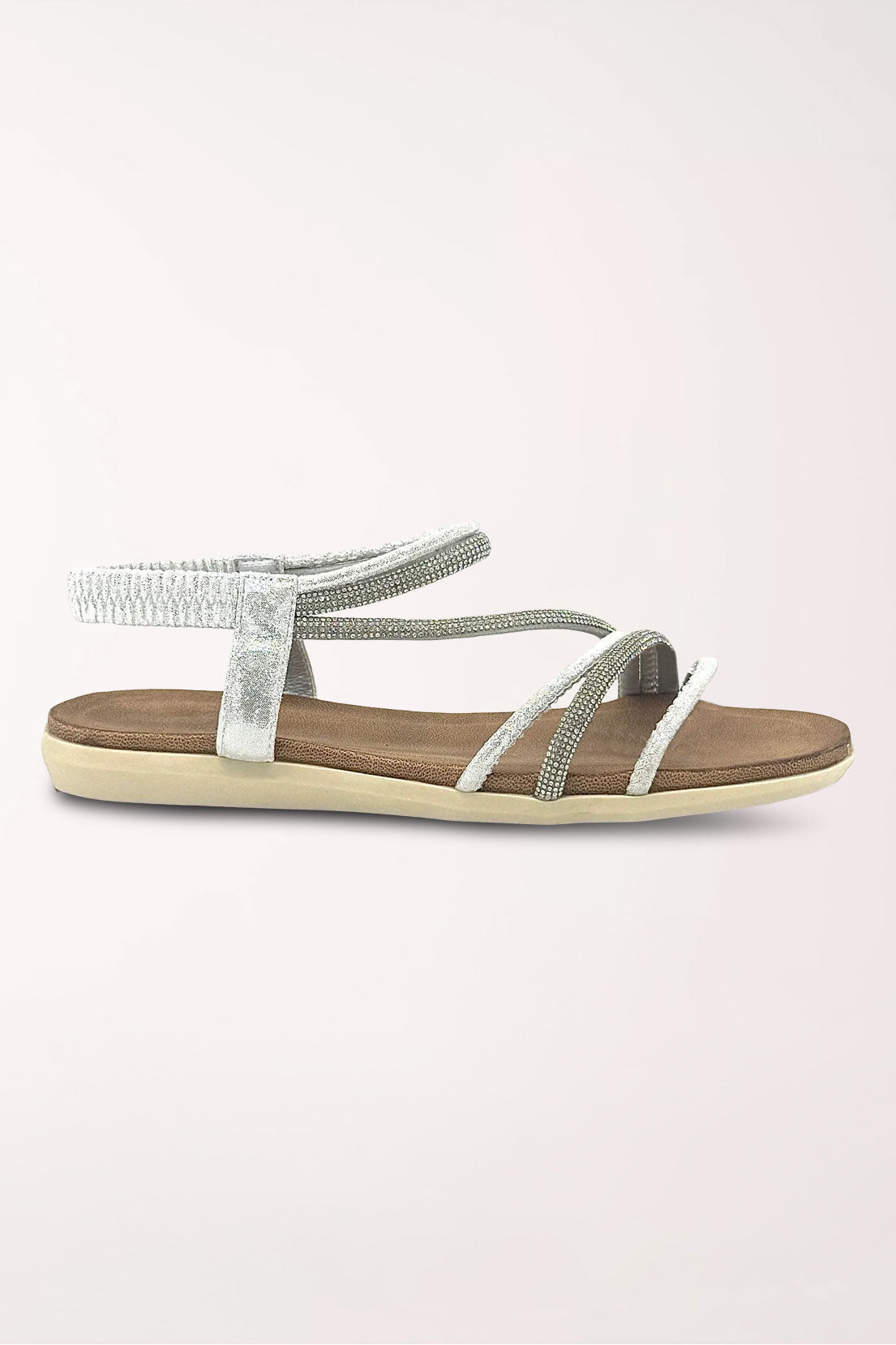 Side profile of the silver Alina rhinestone flat sandal showing the low flat sole.