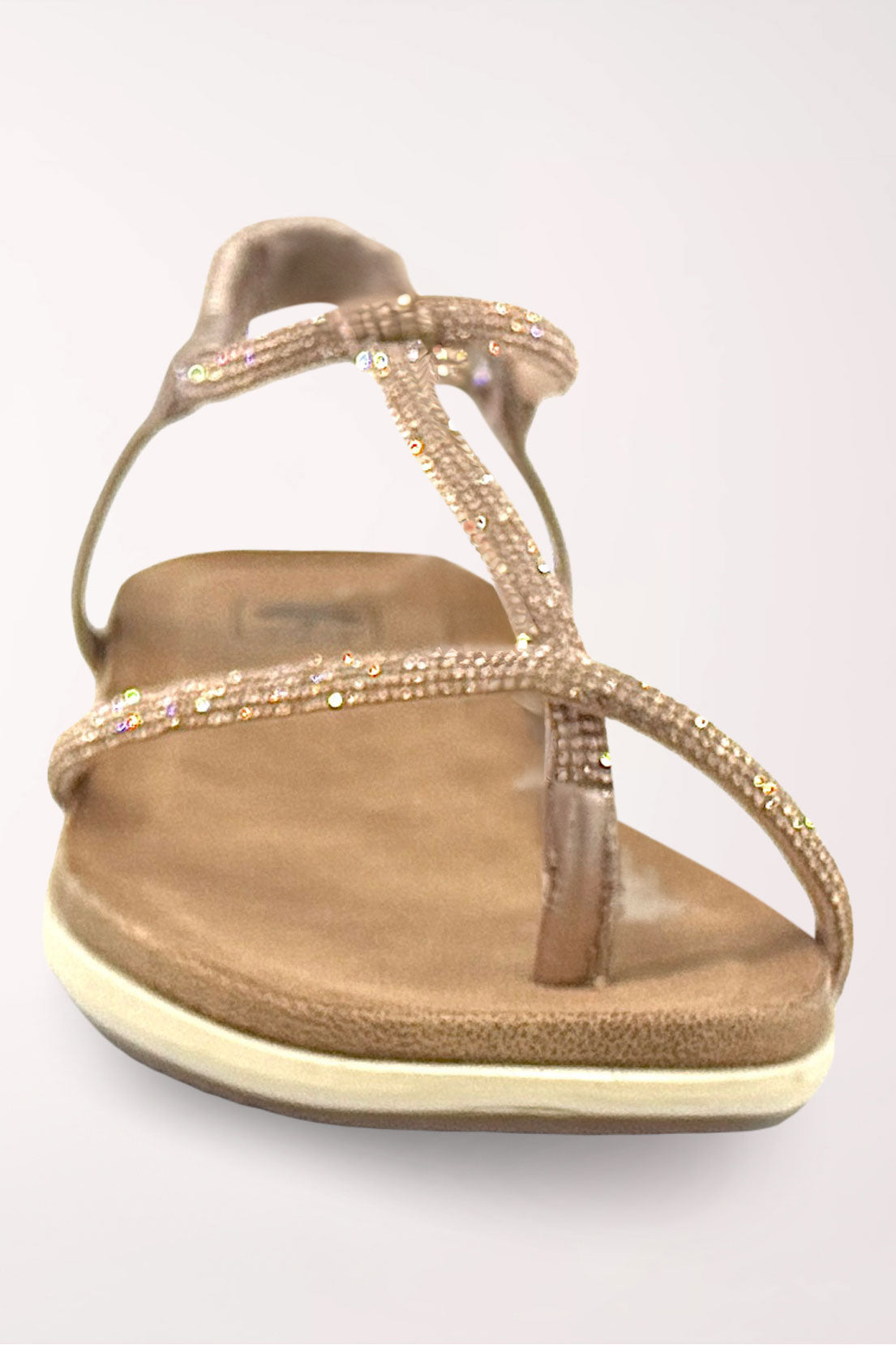 Top-down front view of the champagne Viva sandal showing the rhinestone toe loop and T-strap over the tan footbed.