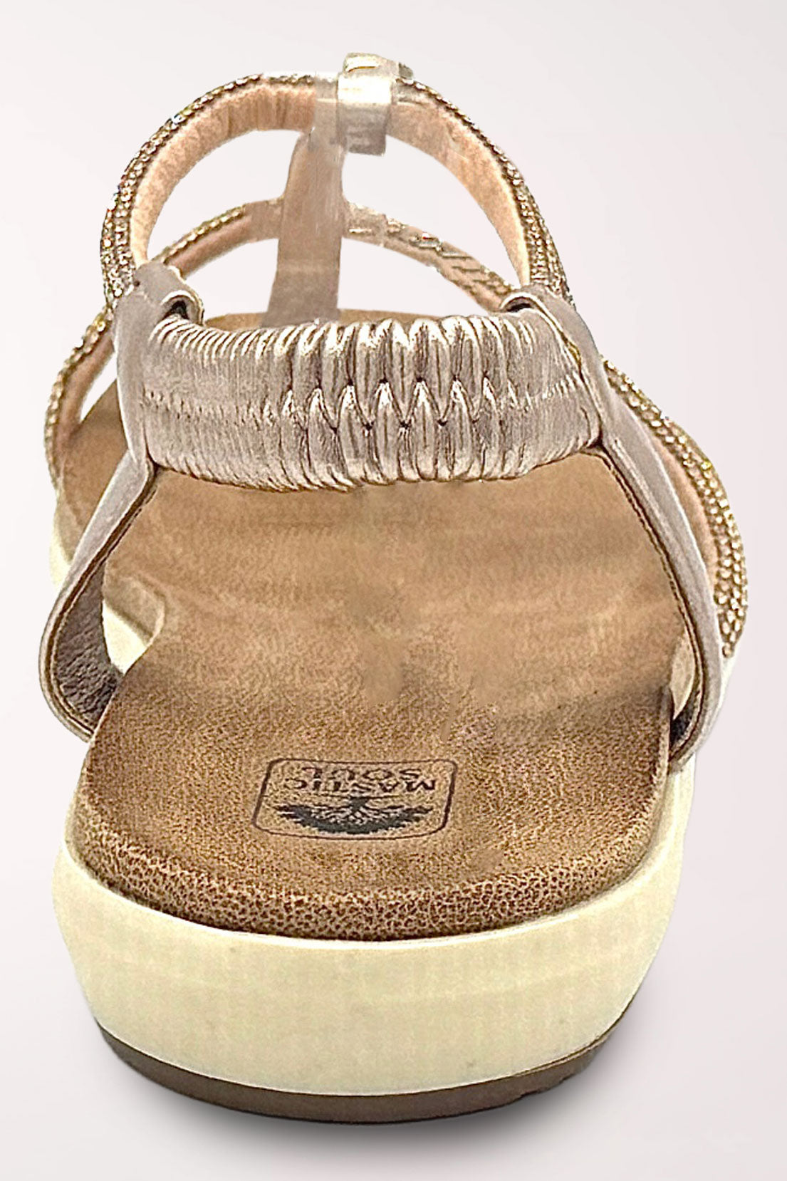 Back view of the champagne Viva sandal showing the stretchy rhinestone slingback strap and cushioned heel.