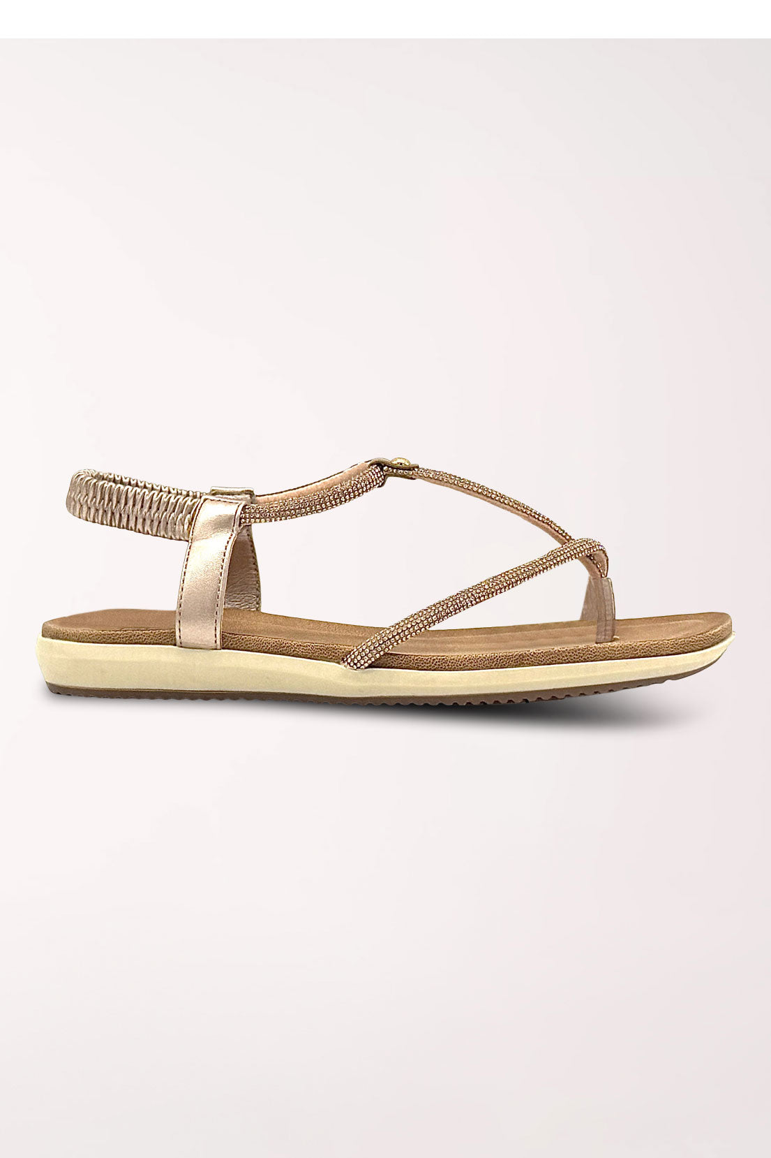 Side profile of the champagne Viva rhinestone flat sandal showing the low flat sole and elastic slingback.