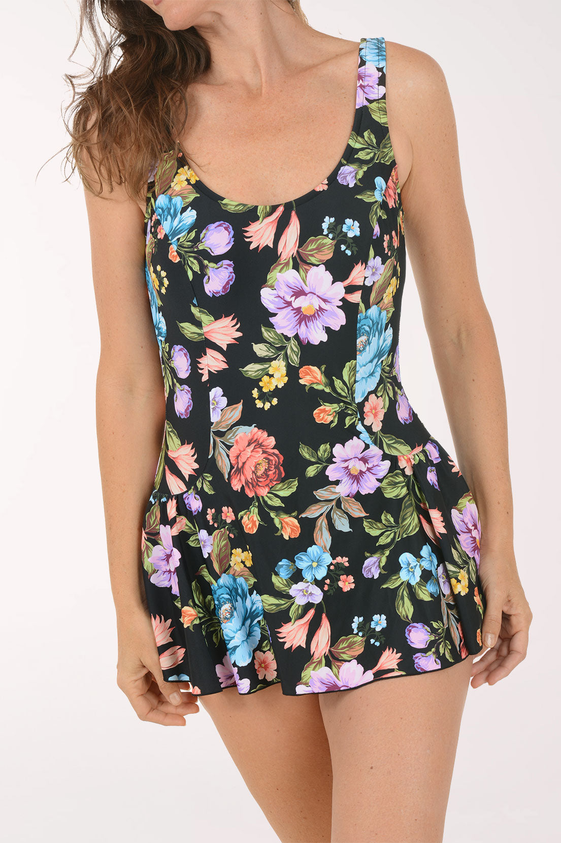 Woman wearing a floral dress on a white background. Detail shot.