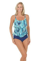 A woman wearing a blue tankini top with a double tiered detail.