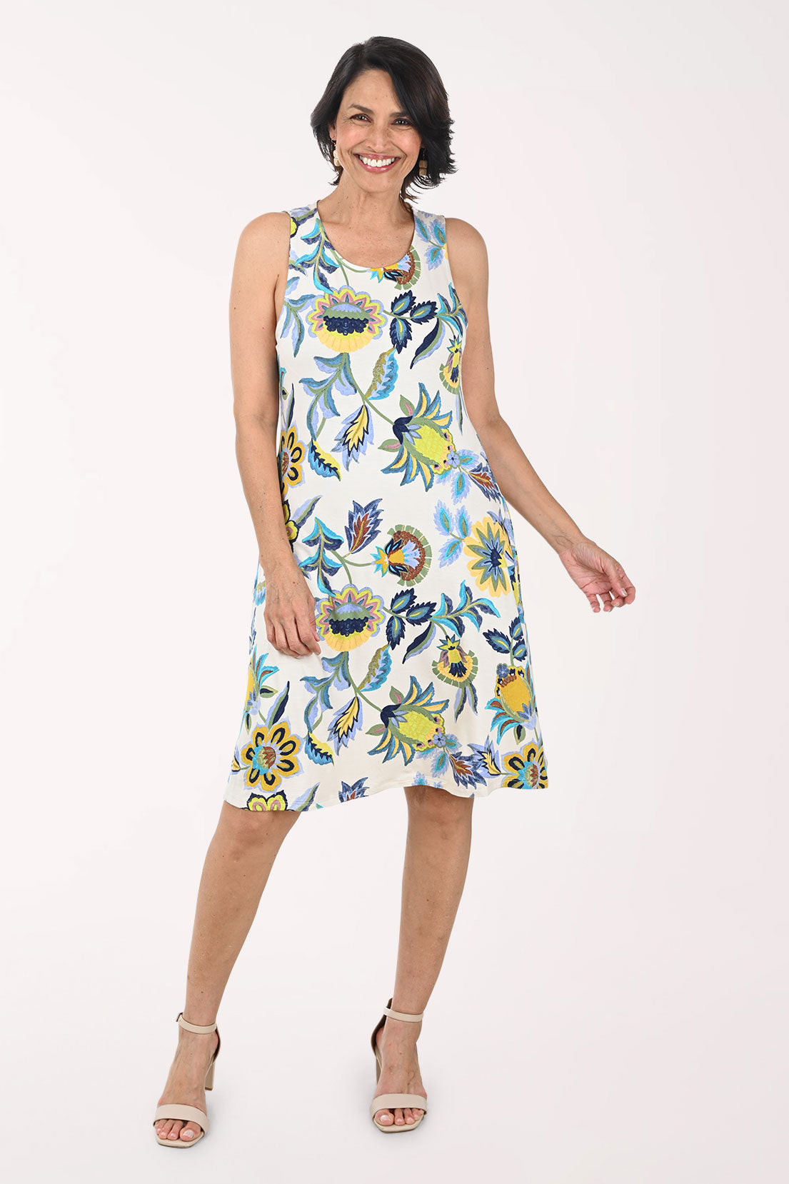 Woman wearing a floral sleeveless dress on a white background
