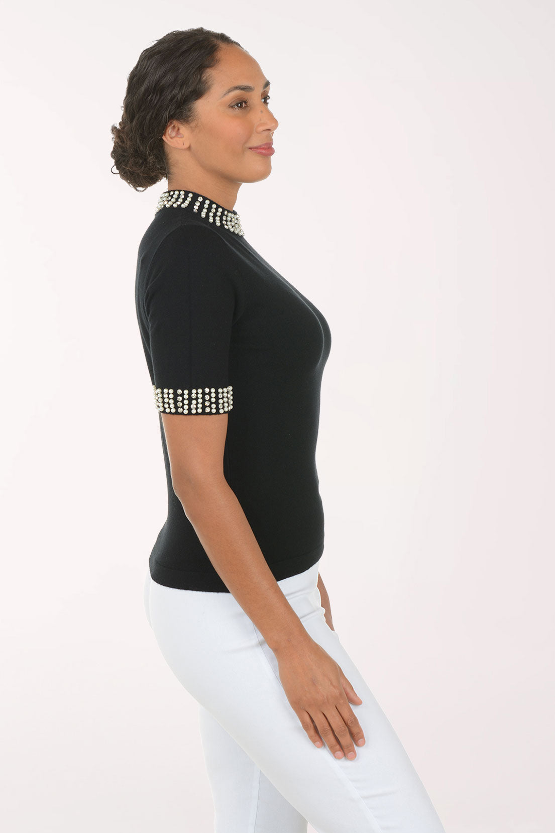 Woman wearing a black short sleeve sweater.