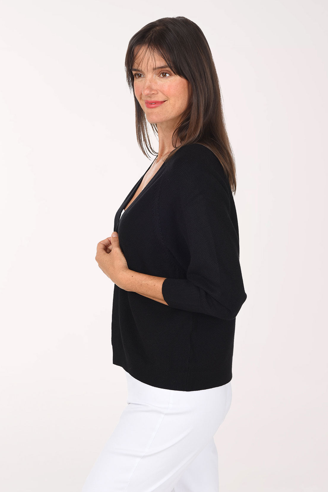 Side view of the black Waffle Knit Open Cardigan showing the raglan sleeve and ribbed hem.
