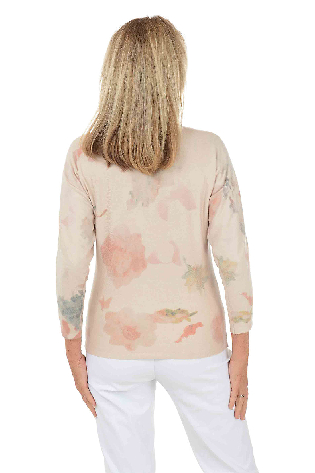 Woman wearing a floral-patterned sweater on a white background
