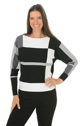 Woman wearing a black, white, and gray striped sweater on a white background.