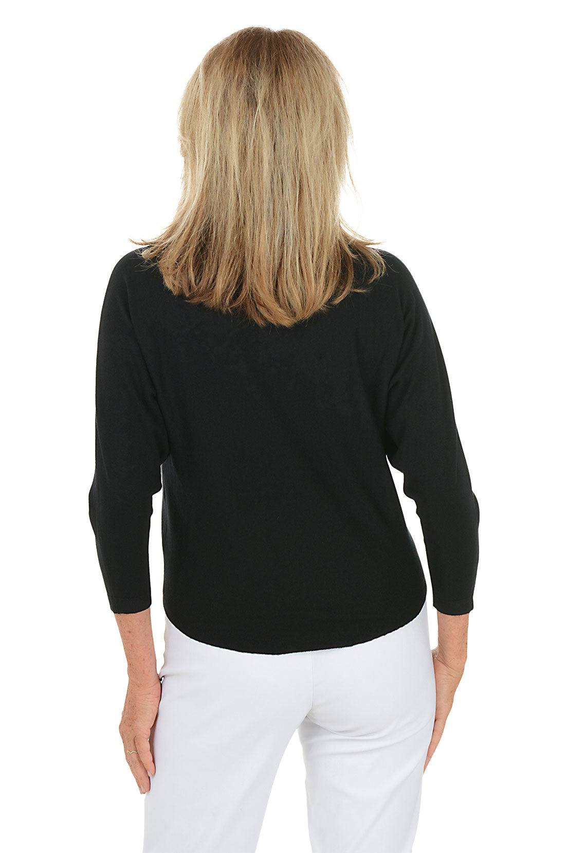 Woman wearing a black sweater with floral designs on a white background. Back shot.
