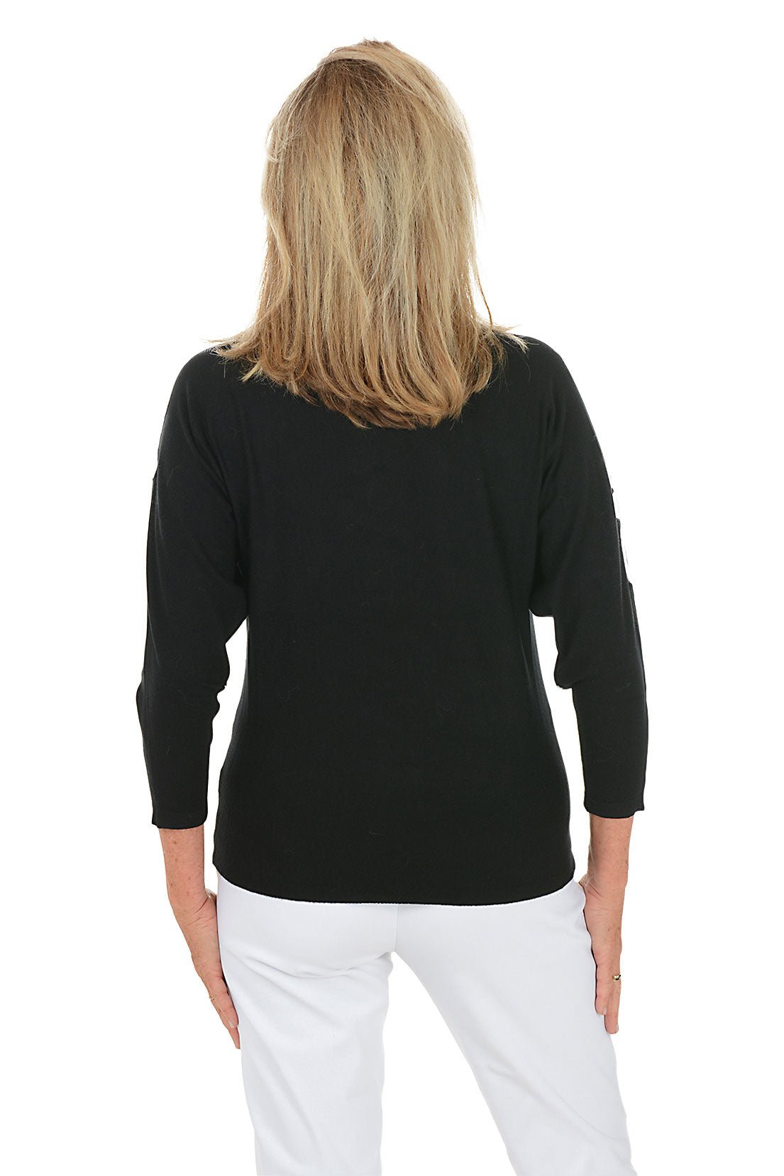 Woman wearing a black sweater with white floral patterned embroidery on a white background. Back shot.