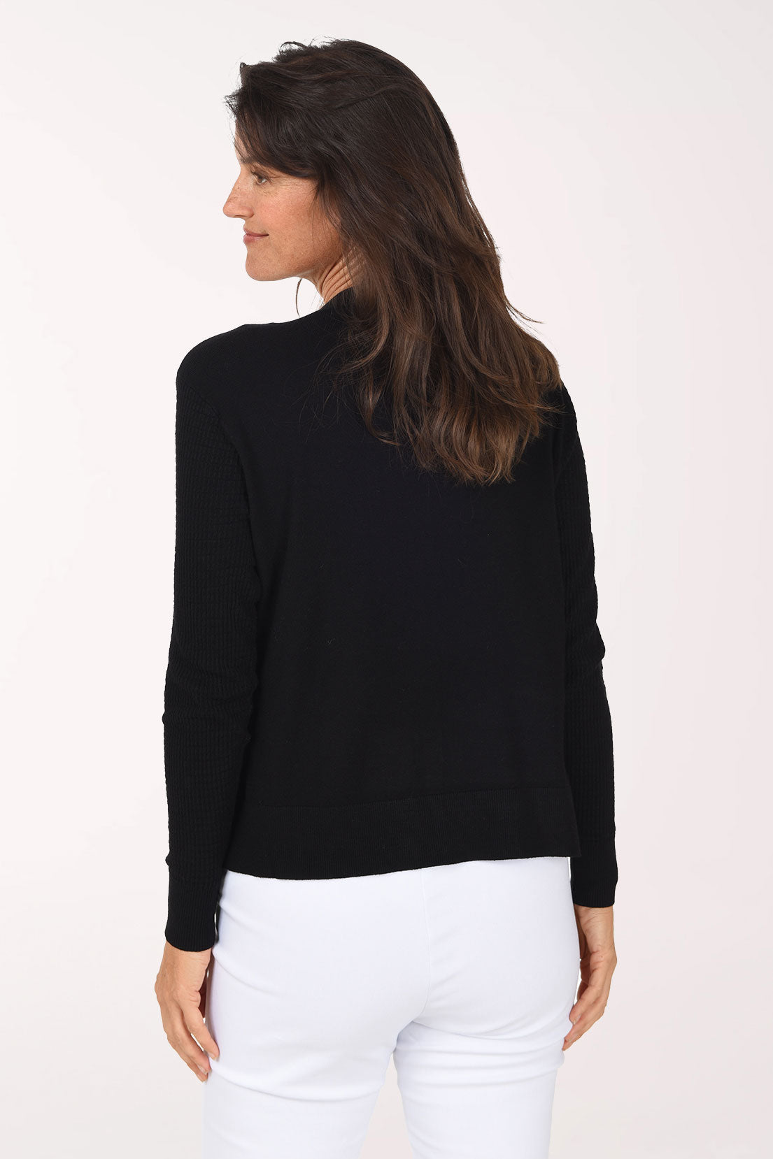 Back view of the black open-front cardigan with a vertical textured knit and ribbed hem